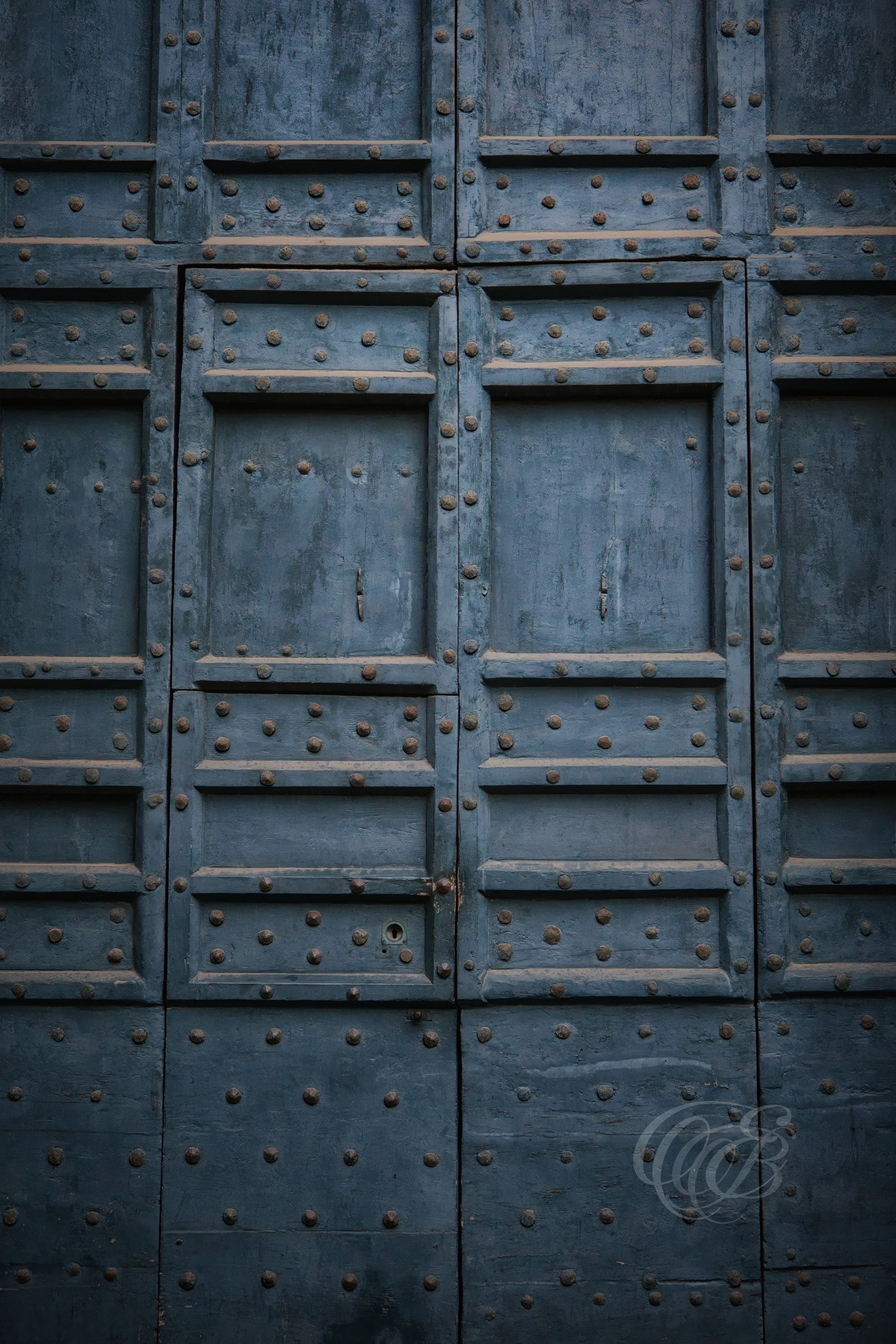 Italy - Rome - Weathered glaucous-colored door in the historic center of Rome, aged architectural detail with textured surface and patina, photography of Italy, Eduardo Bartoli Photography