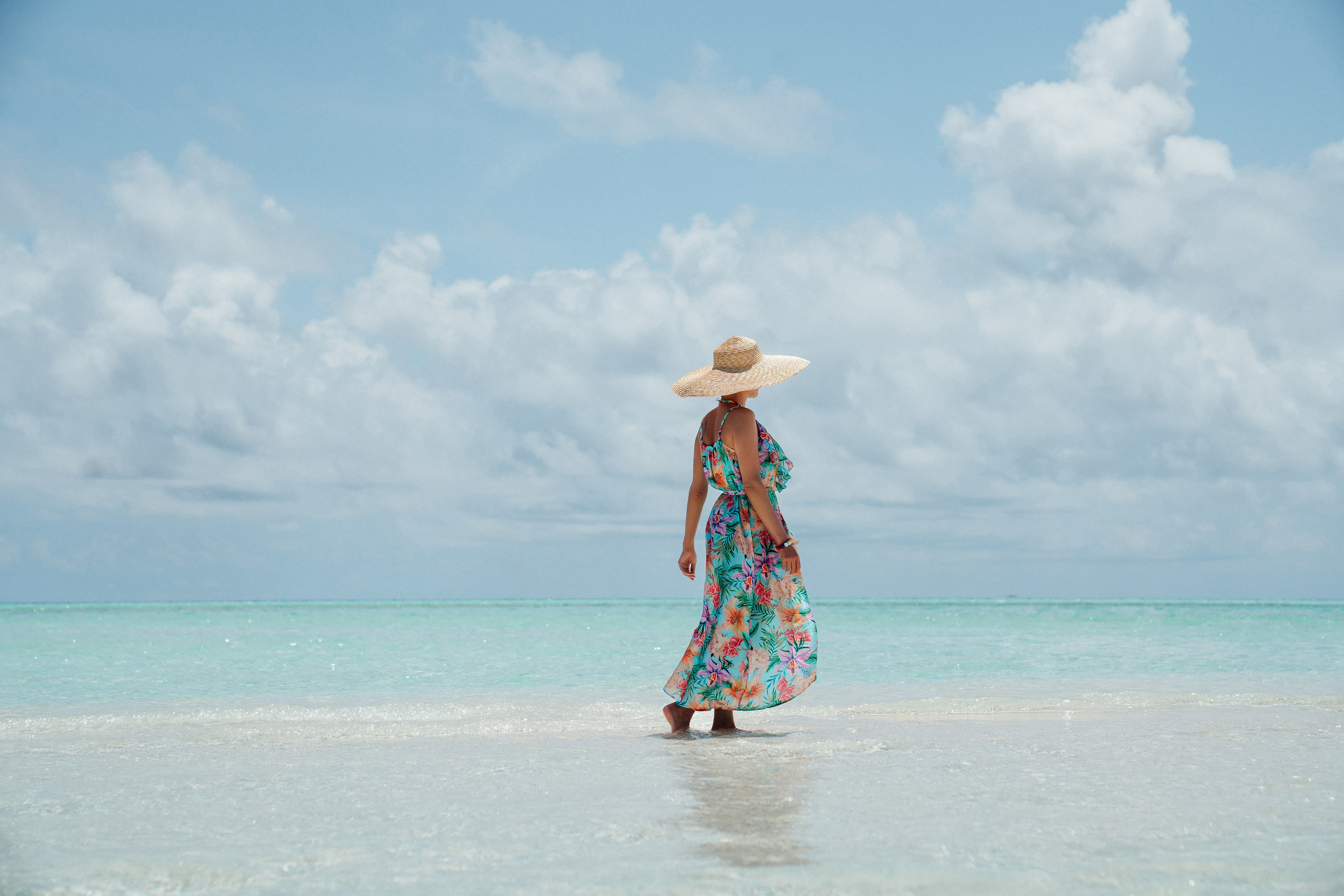 Lifestyle beachwear photography with a model wearing an elegant resort outfit in the Maldives