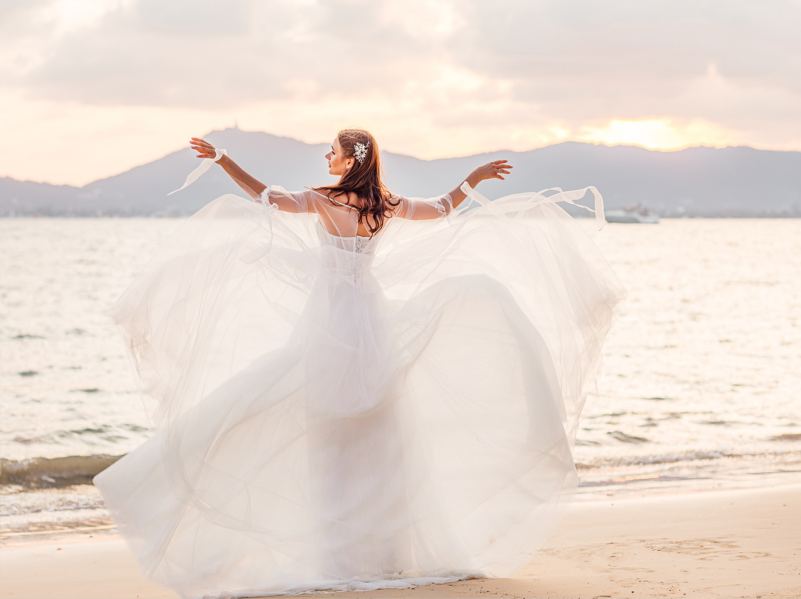 Bridal photography in Phuket featuring a beautiful bride on a tropical beach with ocean views