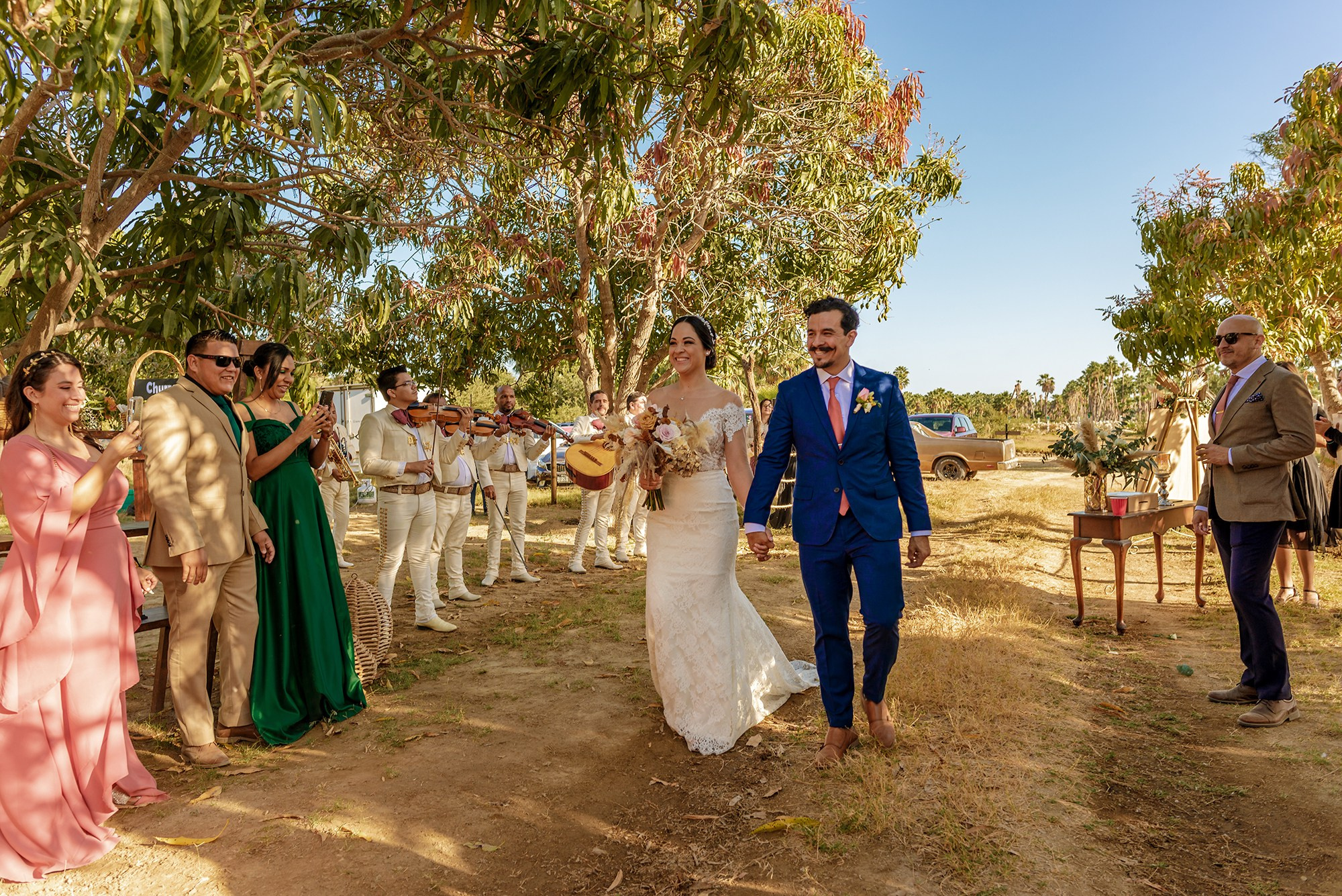 Newlyweds grand entrance with mariachis during outdoor wedding reception in Cabo San Lucas