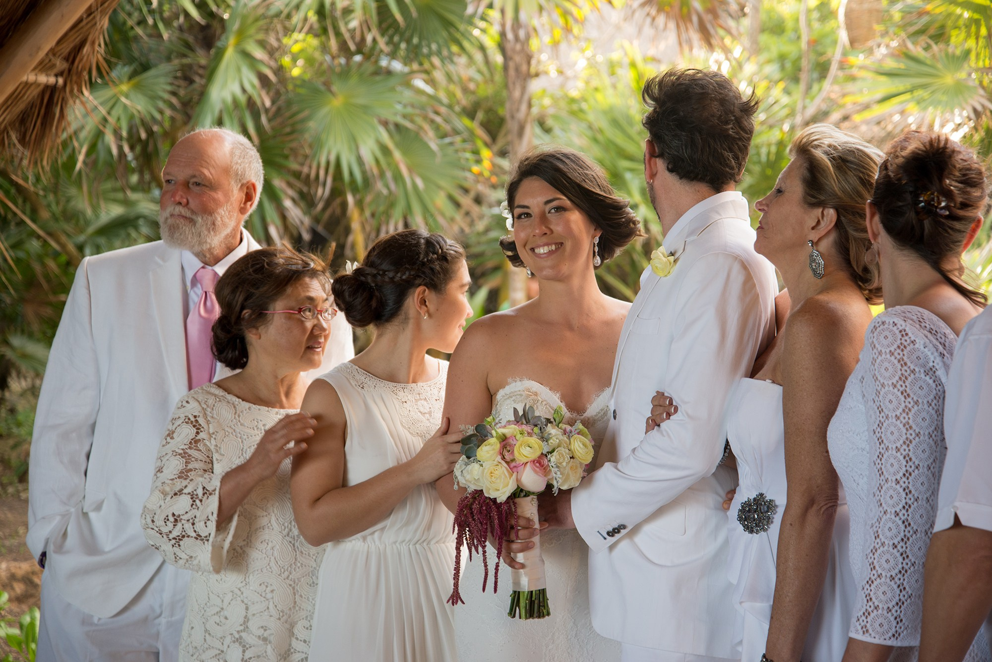 Bride with family during celebration after beach wedding ceremony at Papaya Playa Project, Tulum