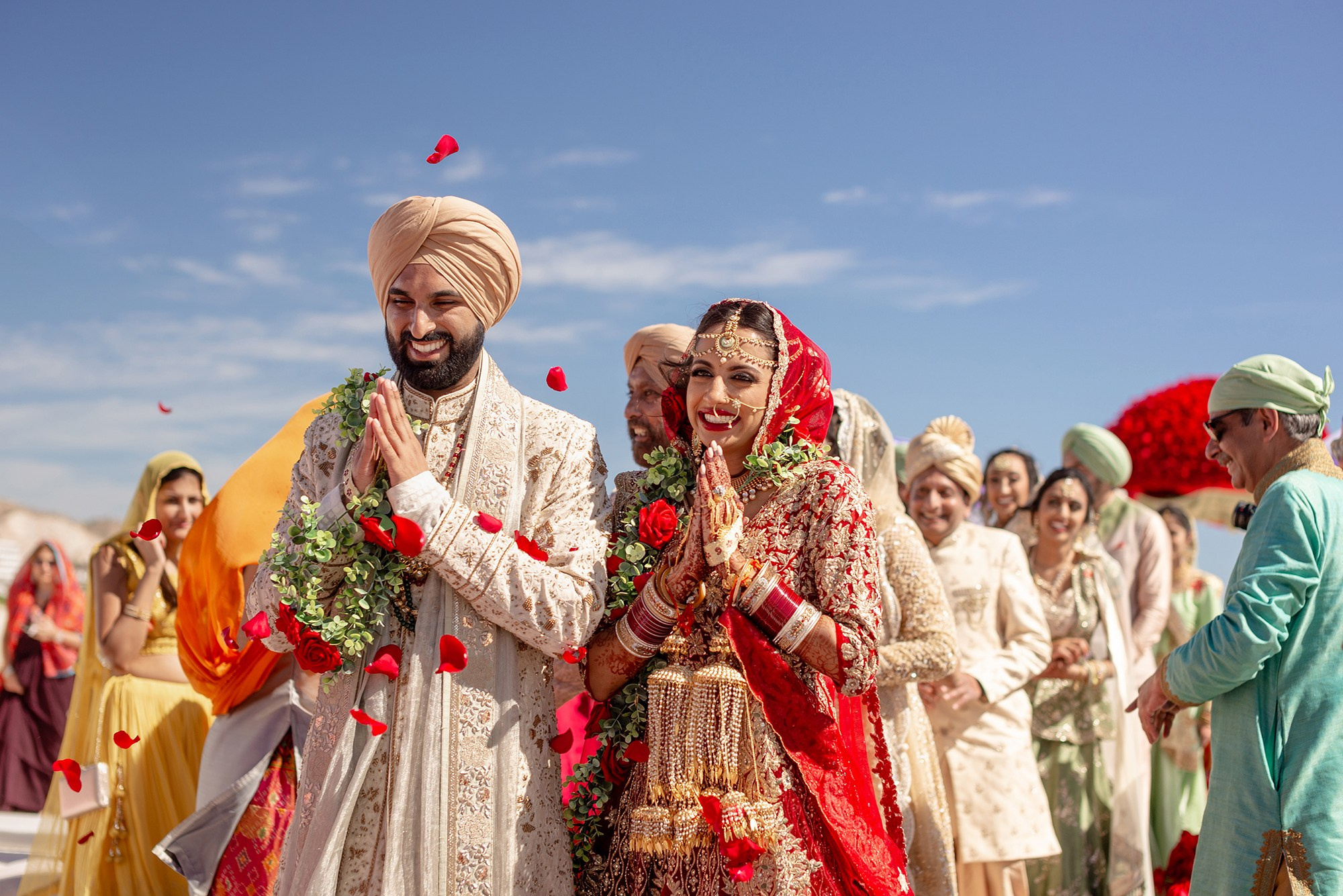 Indian bride and groom with hands together after wedding ceremony at oceanfront venue in Los Cabos