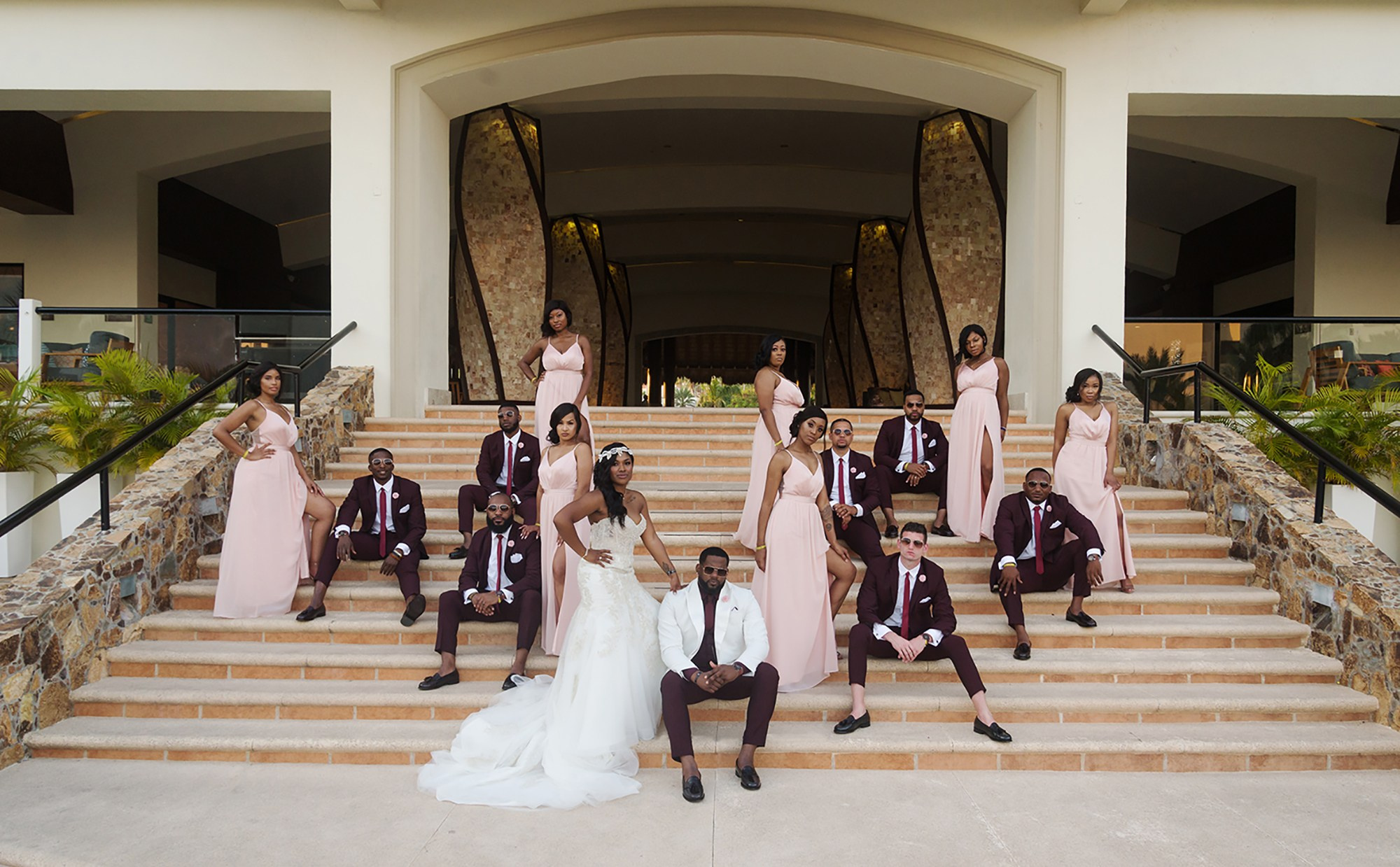Bride, groom, bridesmaids and groomsmen portrait on lobby staircase at Hyatt Ziva Los Cabos