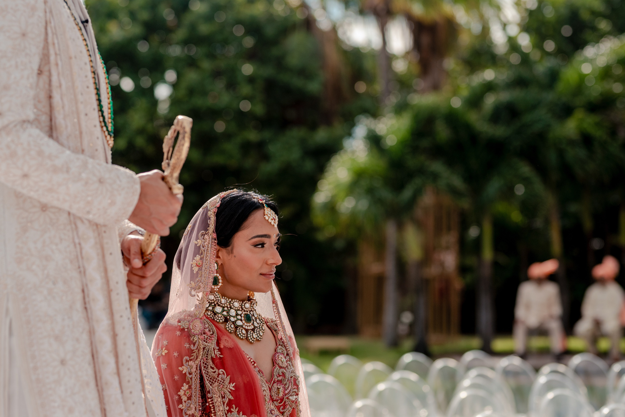 Symbolic Indian wedding portrait showing groom’s sword and bride’s presence during photo session in Cancun