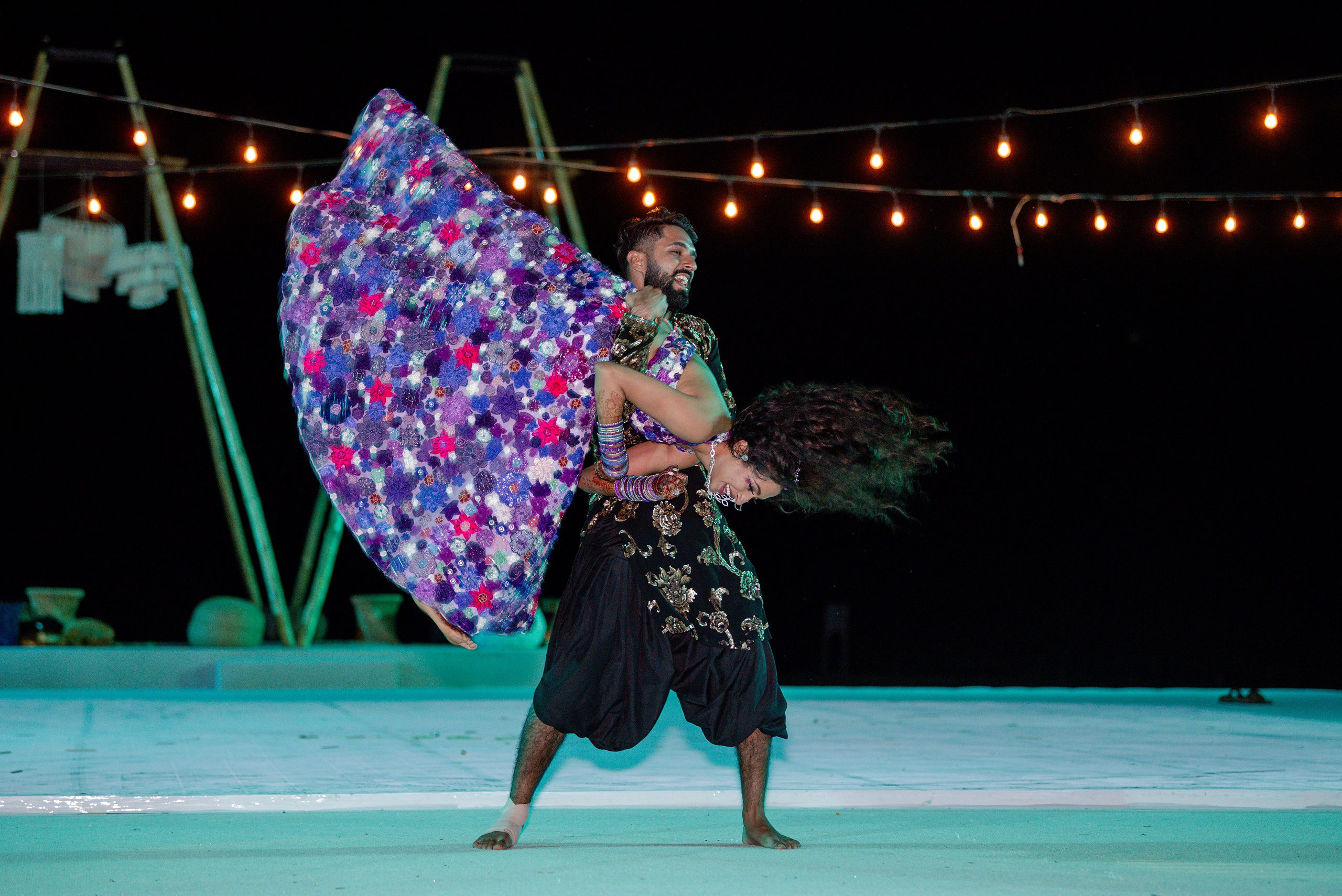 Bride being lifted in celebration during Indian wedding at Paradisus Los Cabos resort