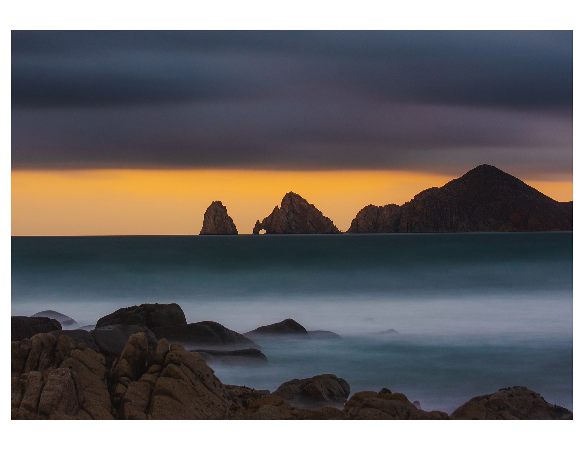 sunset landscape of the arch at san lucas, mexico.