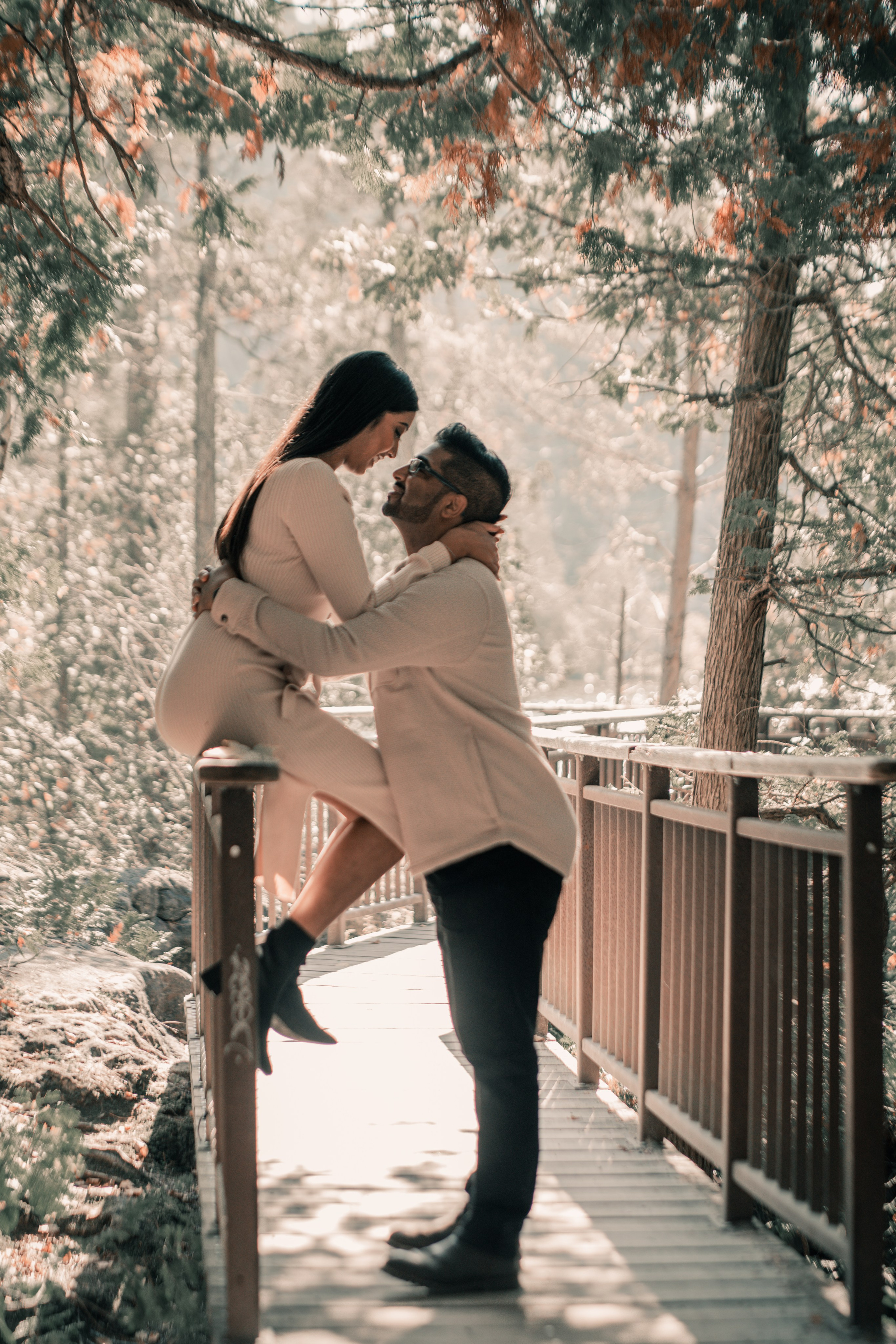 Couple walking through a golden autumn park, capturing their engagement moments