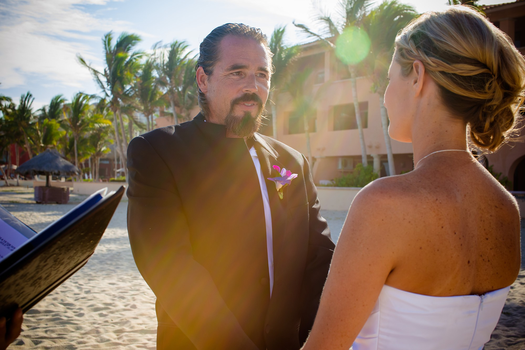 Bride and groom exchanging vows oceanfront during beach wedding in San José del Cabo