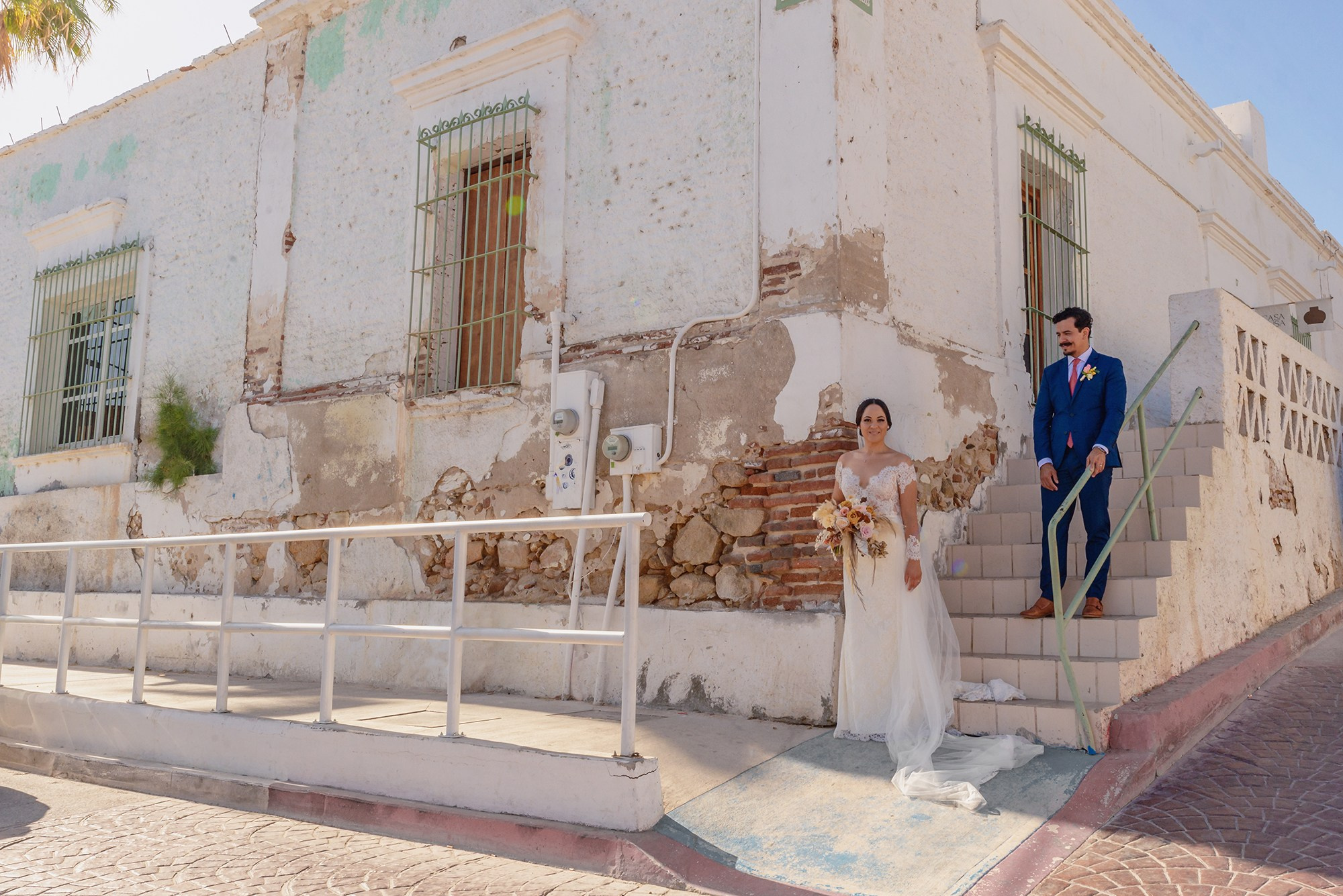 Bride and groom portrait with colonial architecture in historic downtown San José del Cabo