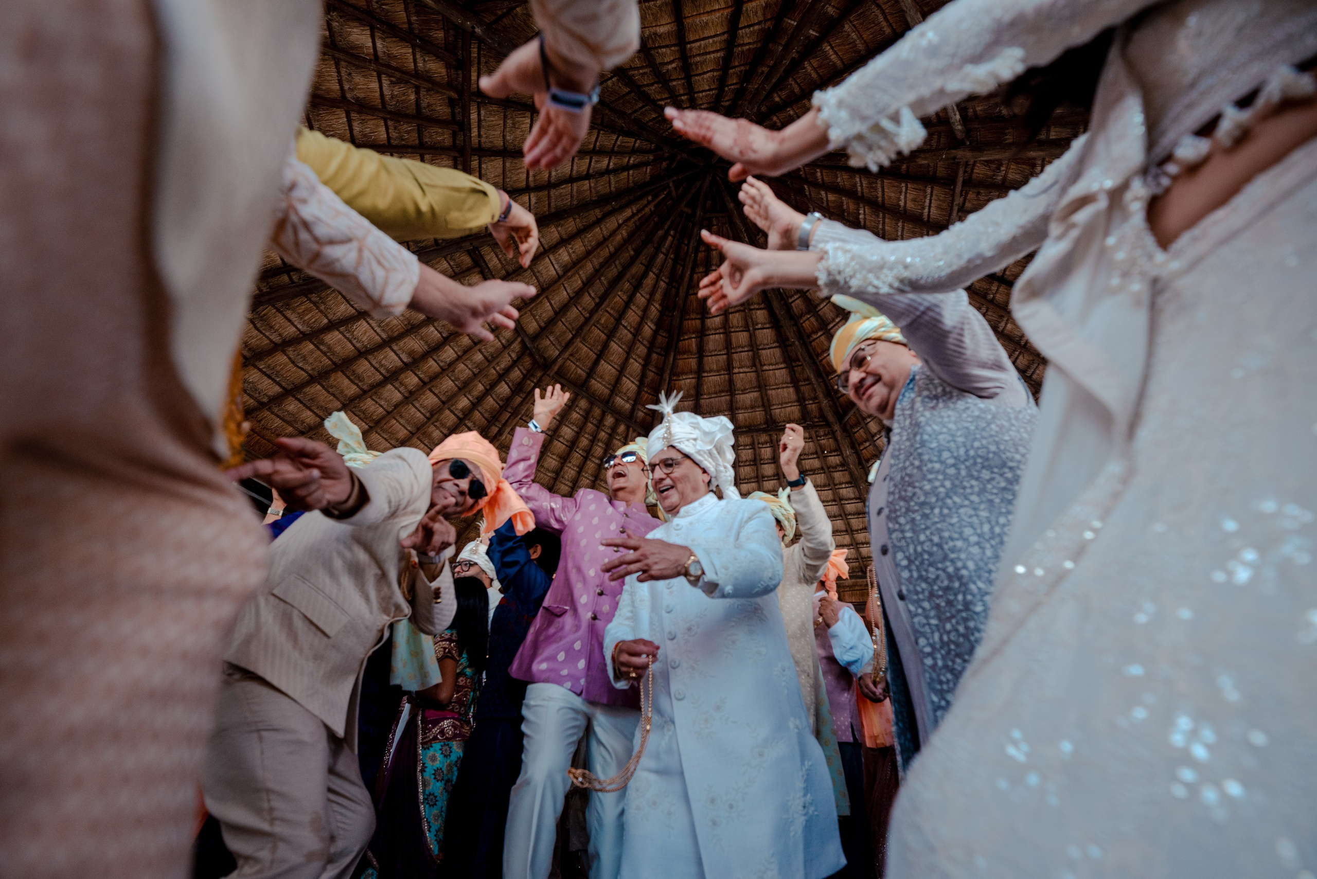 Indian wedding family dancing during the Baraat procession on the way to the ceremony in Cancun