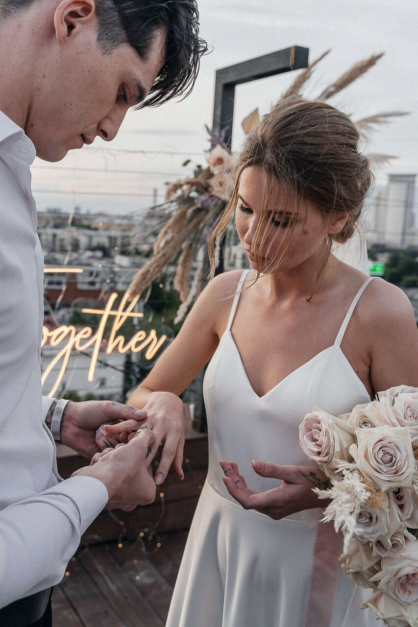 Bride and groom walking hand-in-hand through a picturesque Newmarket venue.