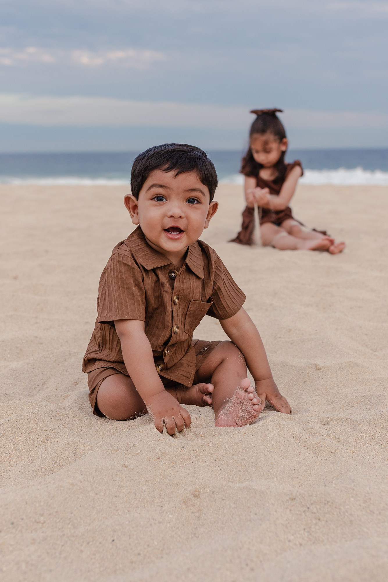 Close-up of a one-year-old boy sitting in the sand at Hyatt Ziva Los Cabos