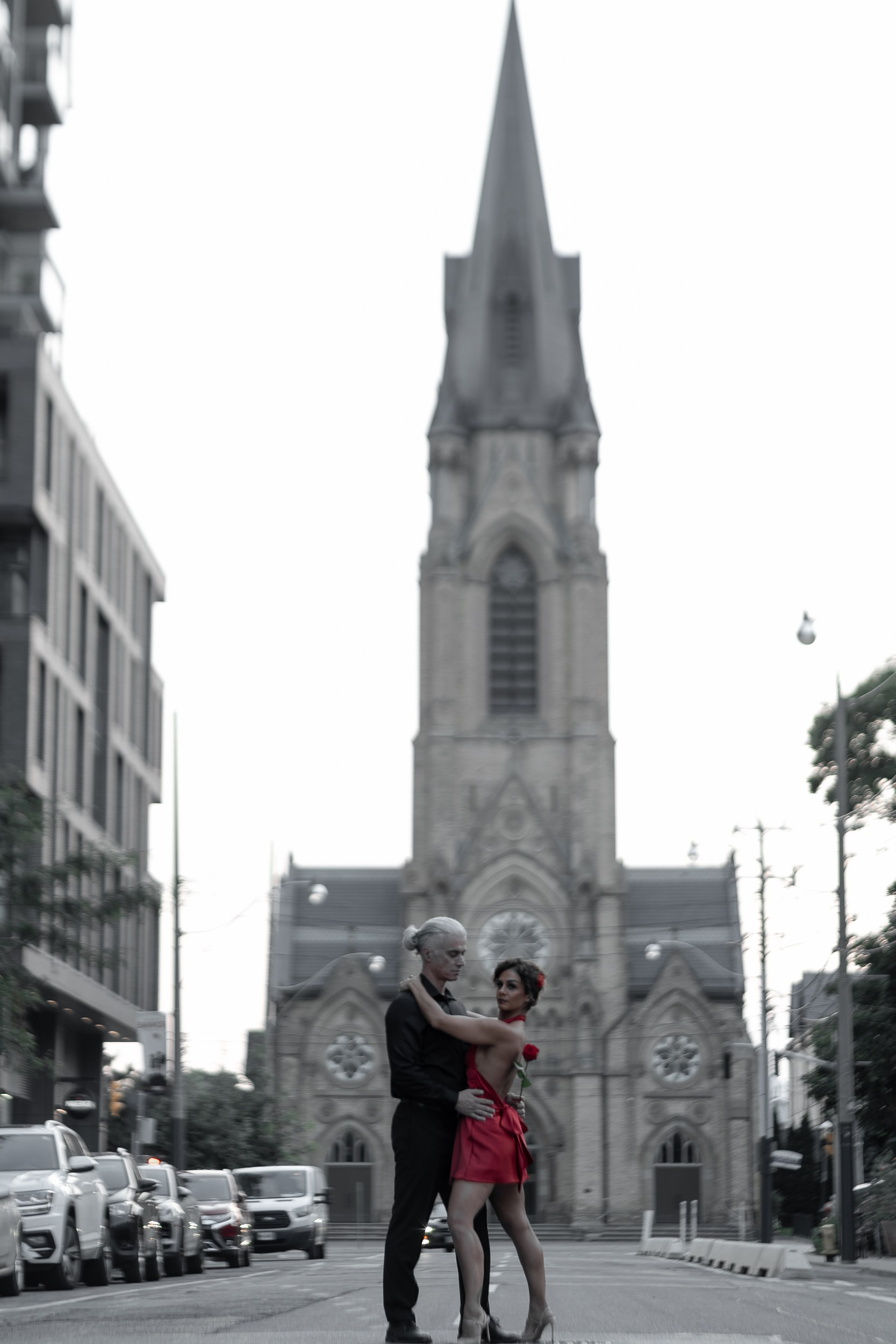 Stylish couple standing with Toronto skyline in the background — modern love story