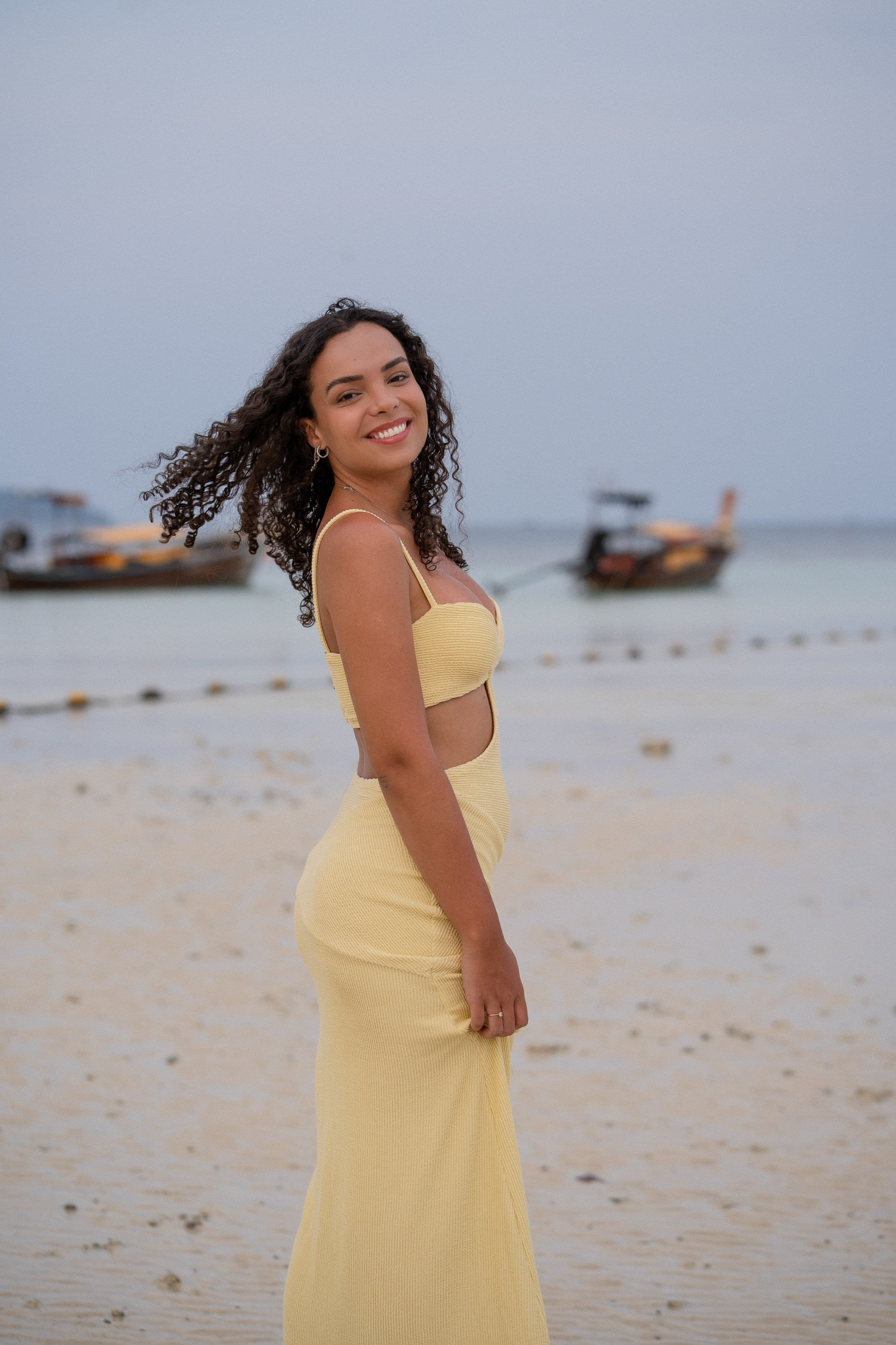 Creative portrait photography in Phuket featuring an elegant woman against a tropical ocean backdrop