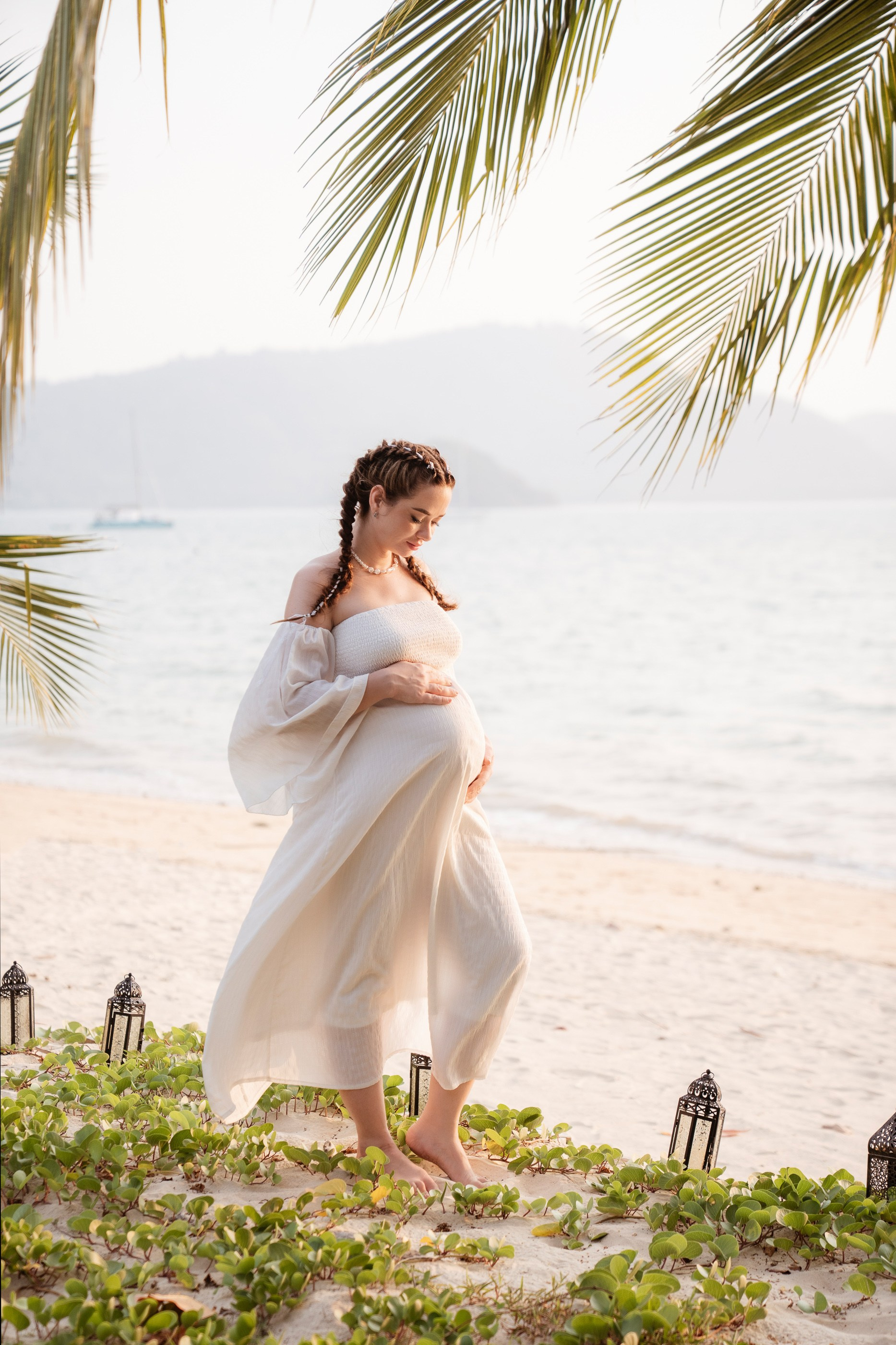 Fine art maternity photography in Phuket with an expecting mother against a tropical ocean backdrop
