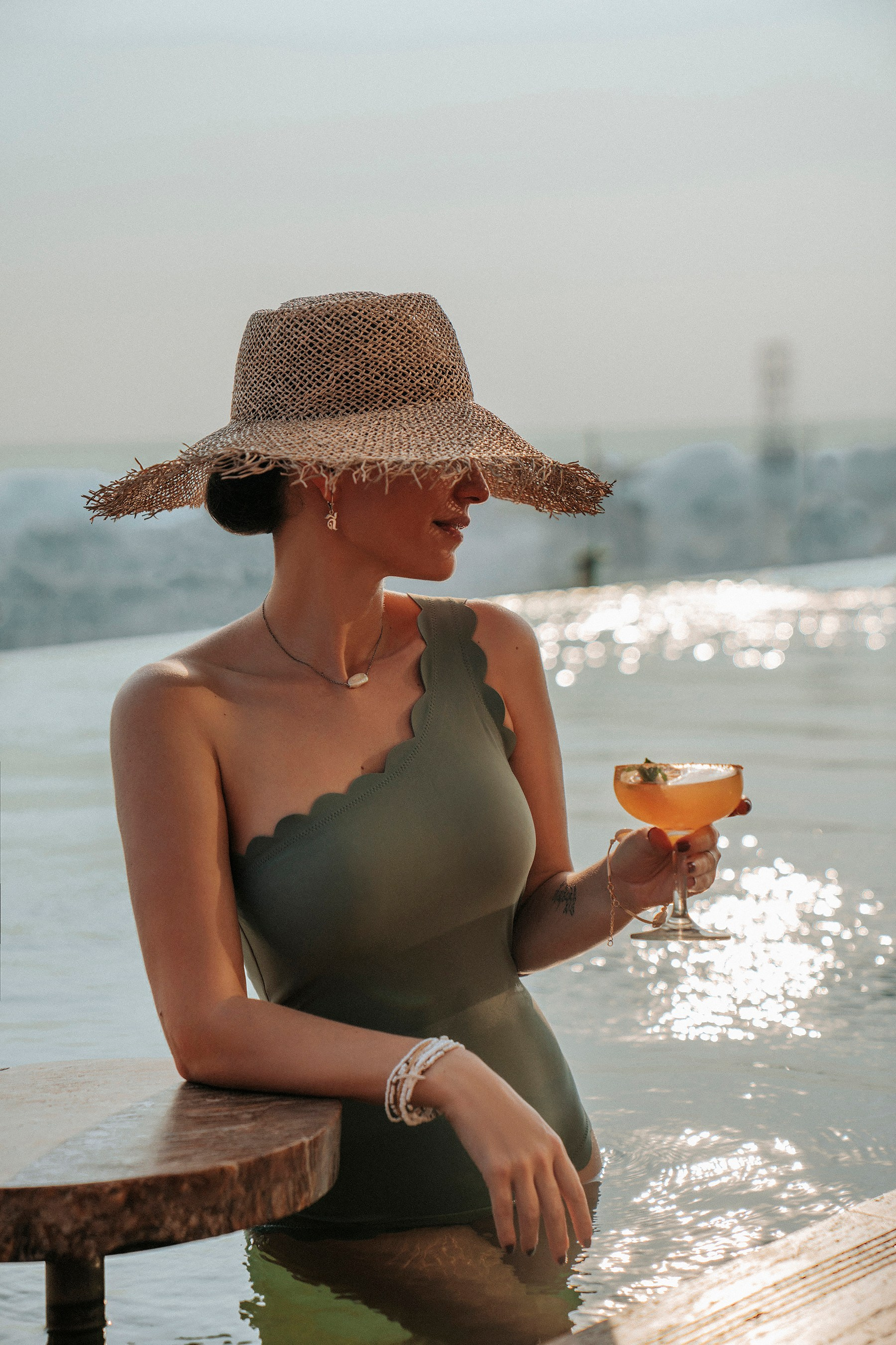 Luxury resortwear lifestyle photography with a female model by the pool