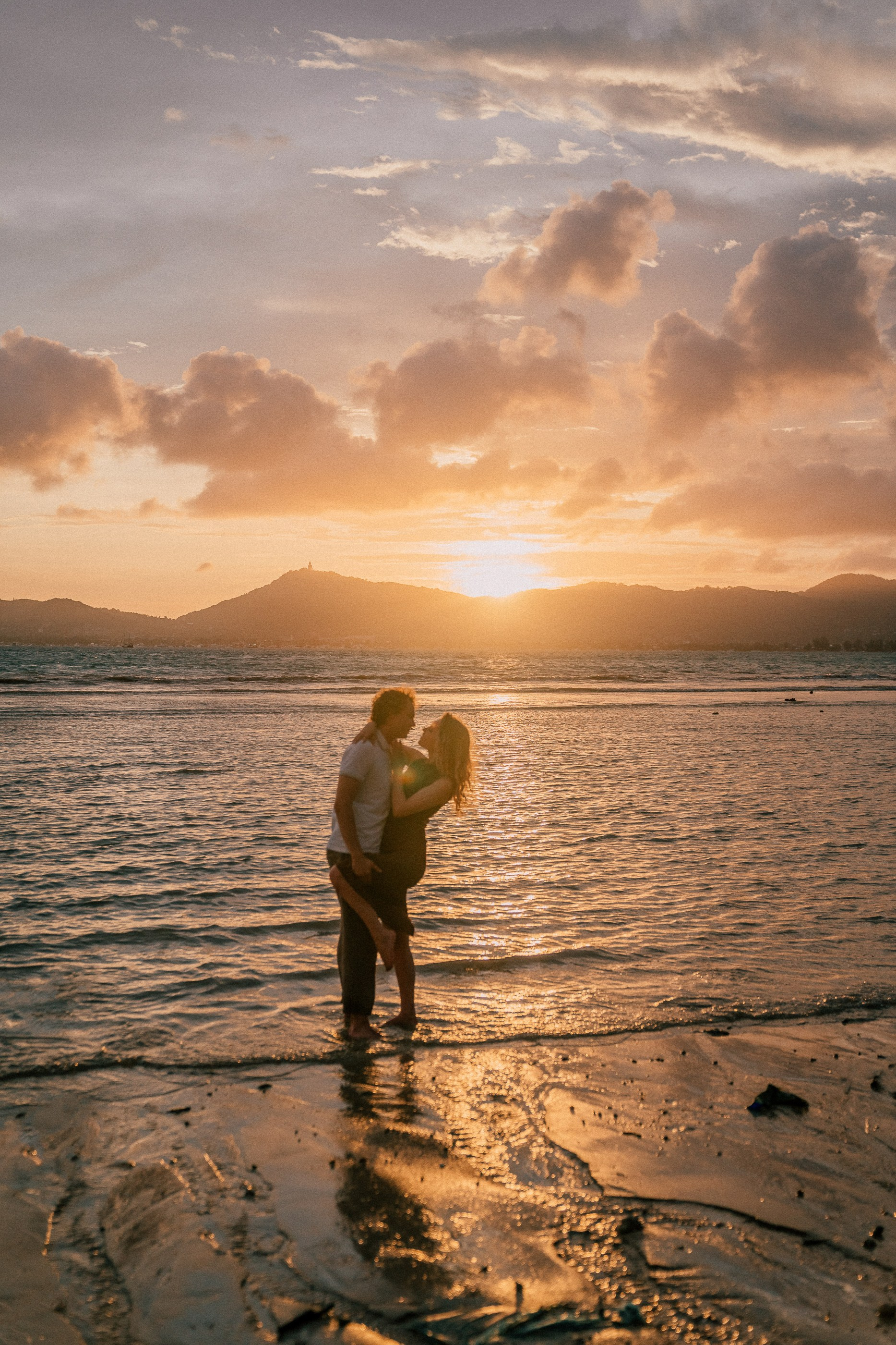 Beach couple photography in Phuket featuring a loving couple walking along the coastline