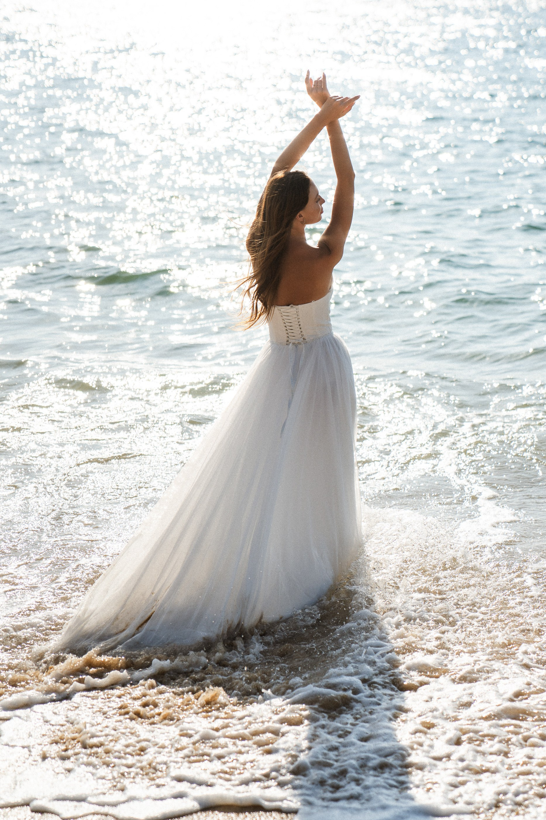 Romantic beach photoshoot in Phuket, Thailand capturing a bride in an intimate tropical setting