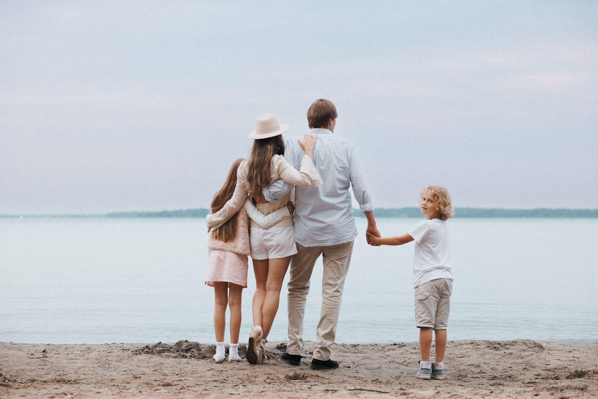 Family of four walking by the water during a Montreal family photography session