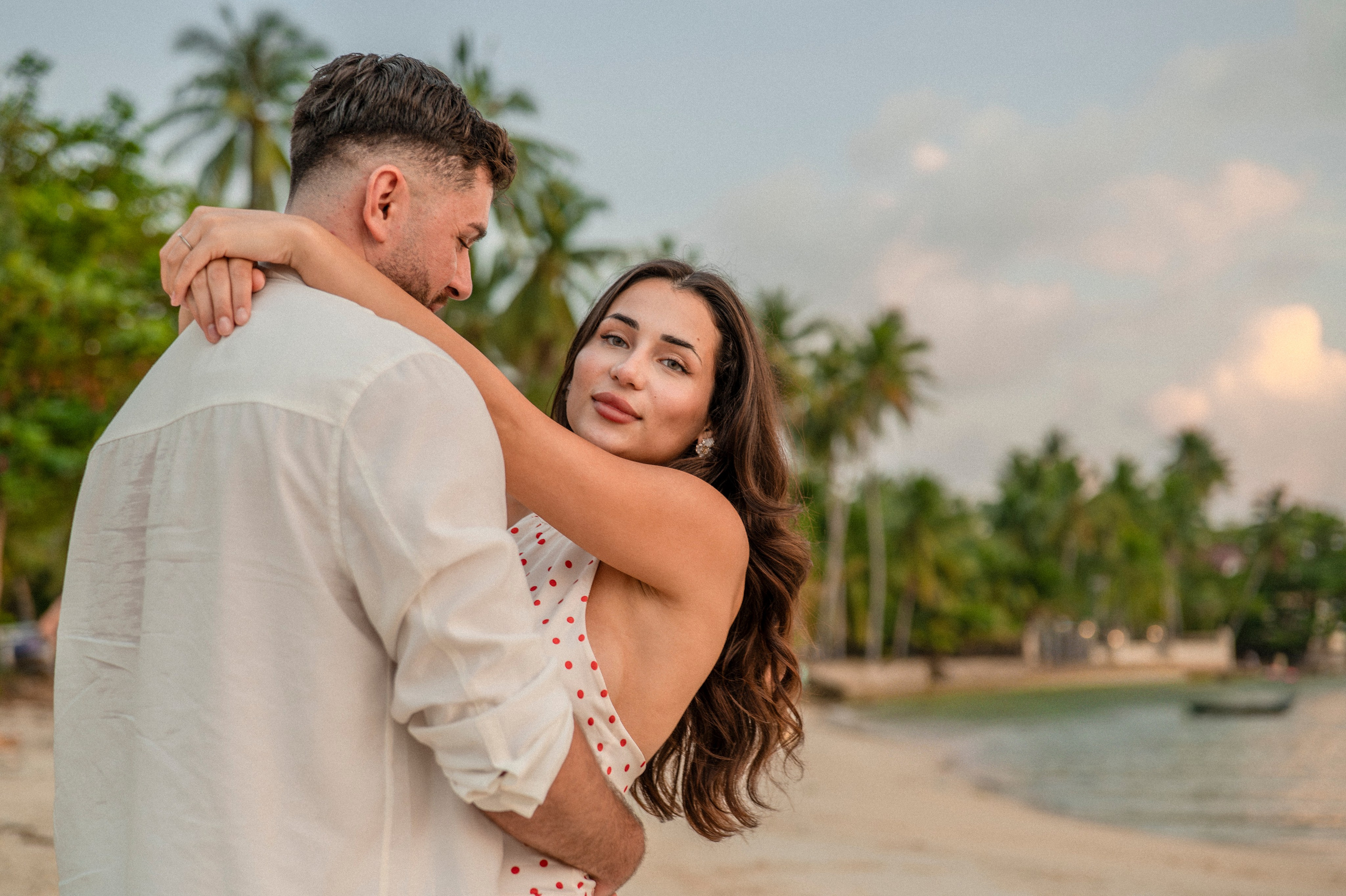 Happy couple embracing on the beach in Pattaya after saying “Yes” to a marriage proposal.