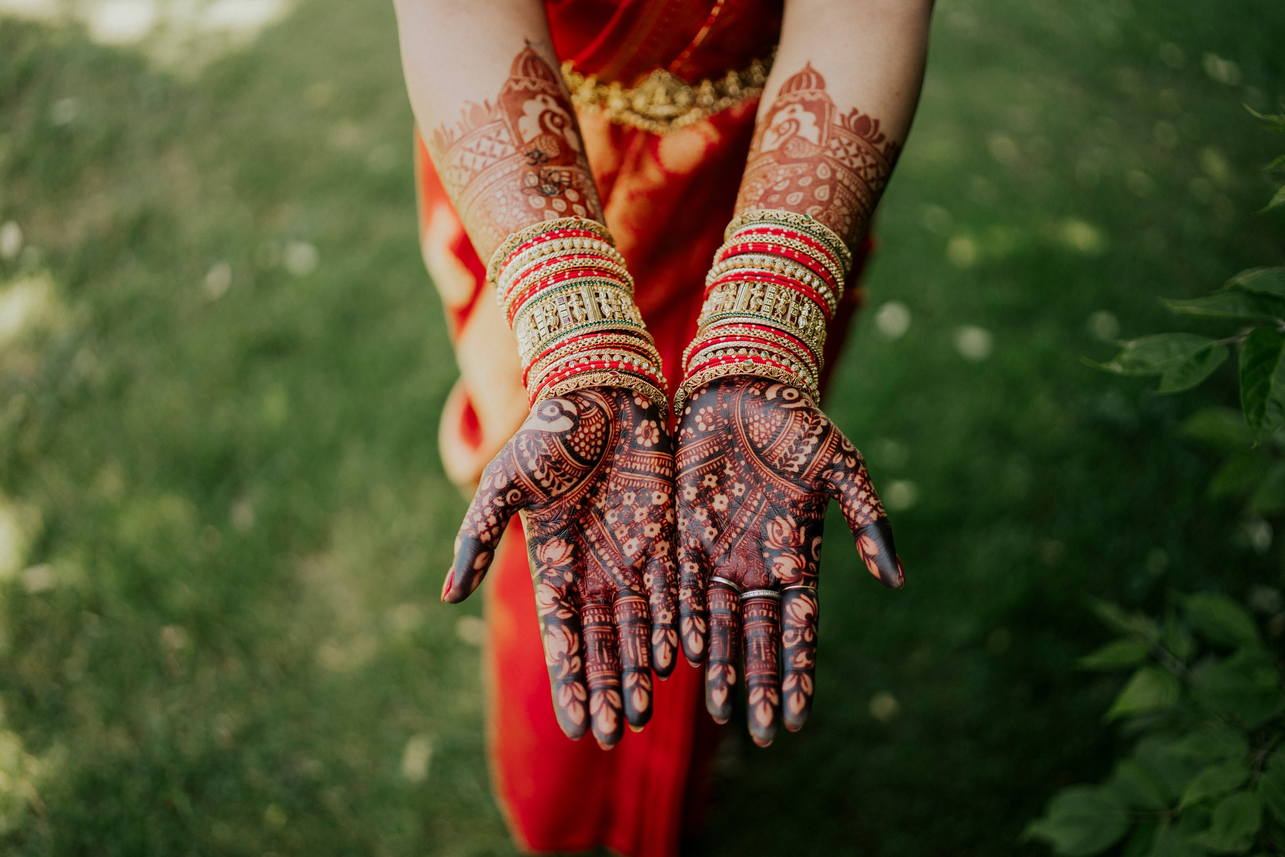Bride showing hands adorned with traditional mehendi designs