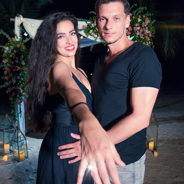 Romantic beach proposal setup in Koh Samui with candles and flower arch.