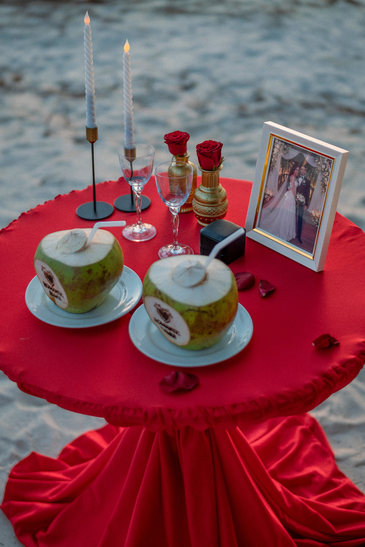 Couple enjoying a romantic dinner and raising cocktails together after a marriage proposal in Pattaya.