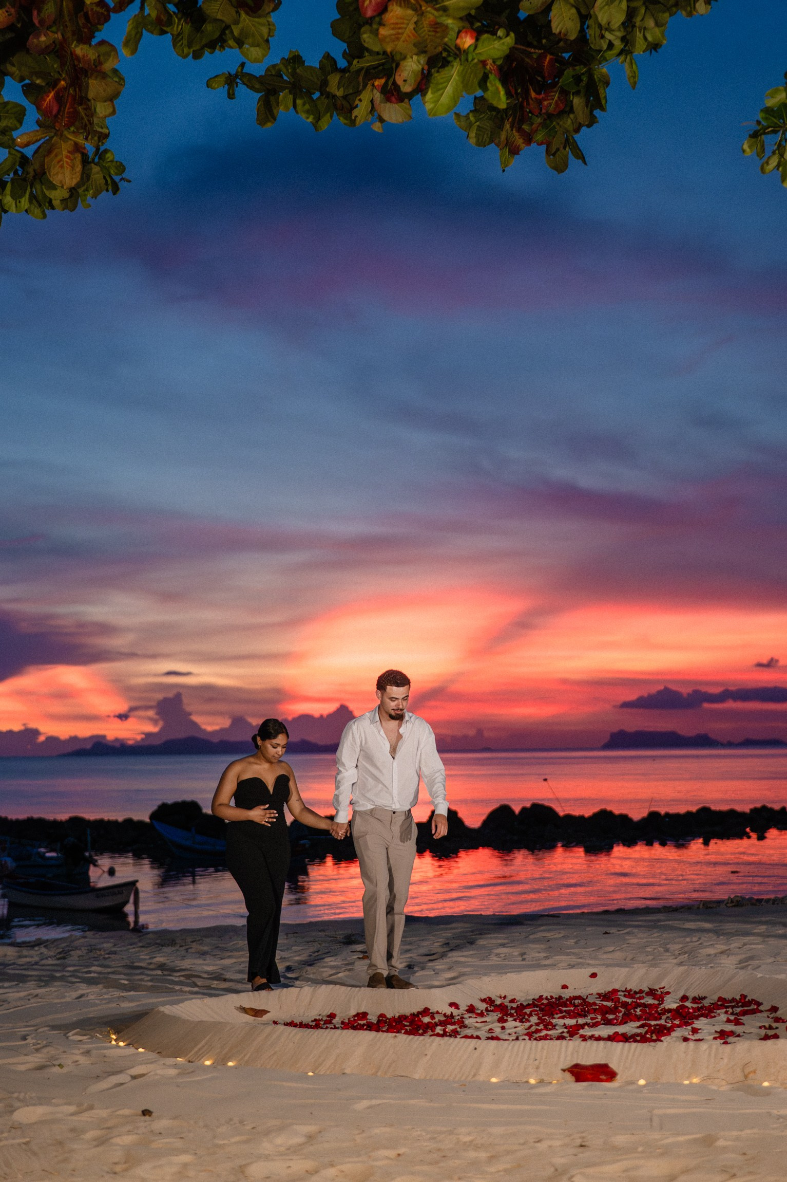 Romantic couple walking on the beach in Pattaya after a sunset marriage proposal.