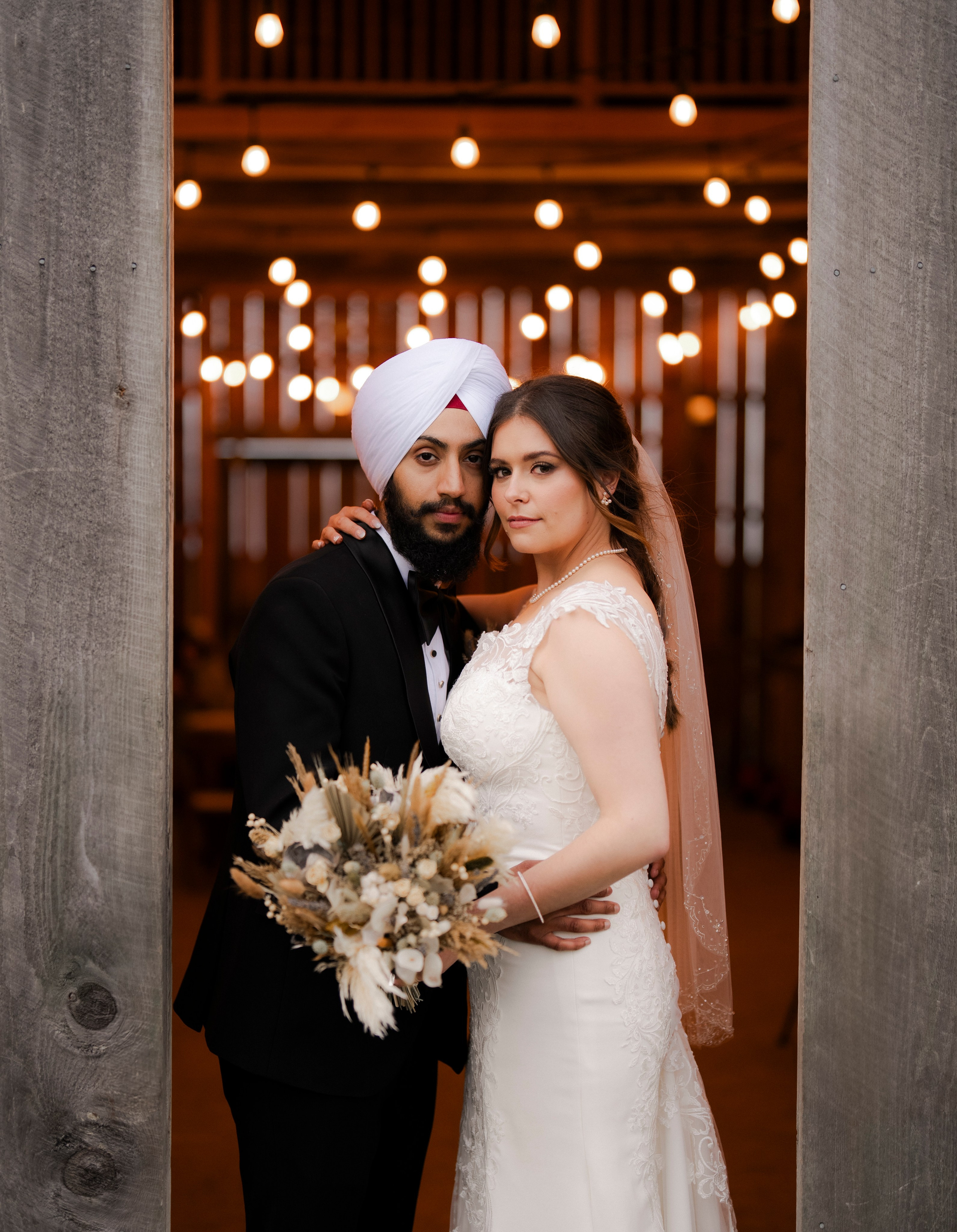 Bride and groom celebrating under fairy lights during their wedding reception
