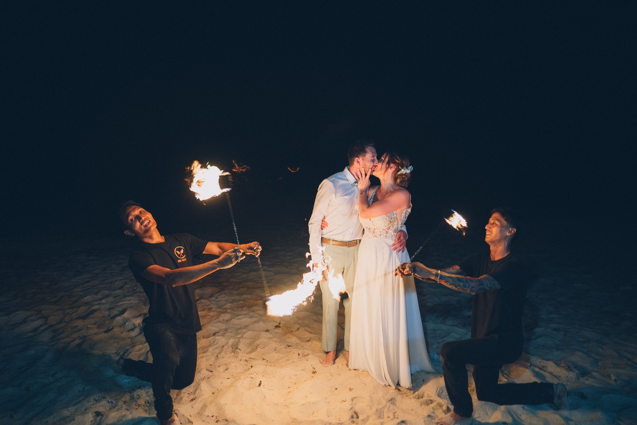 Spectacular fire show performance during a beach wedding reception in Koh Samui