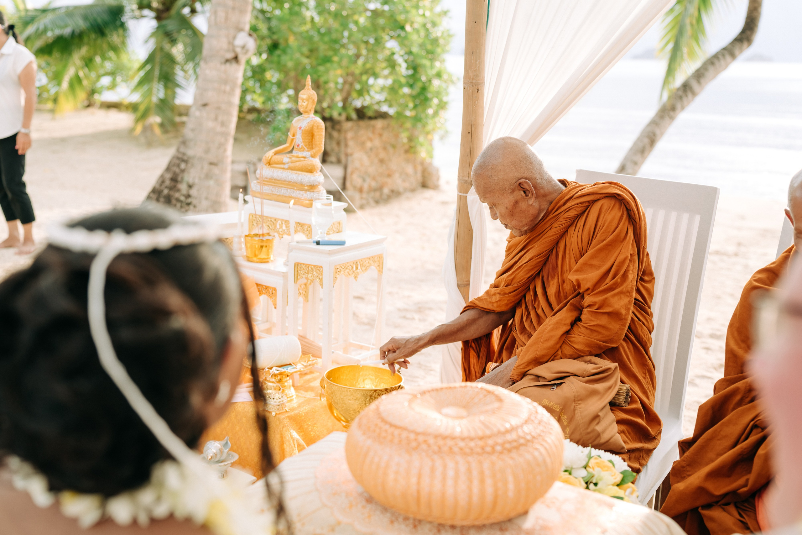 Couple celebrating a spiritual Buddhist wedding ceremony on Koh Samui
