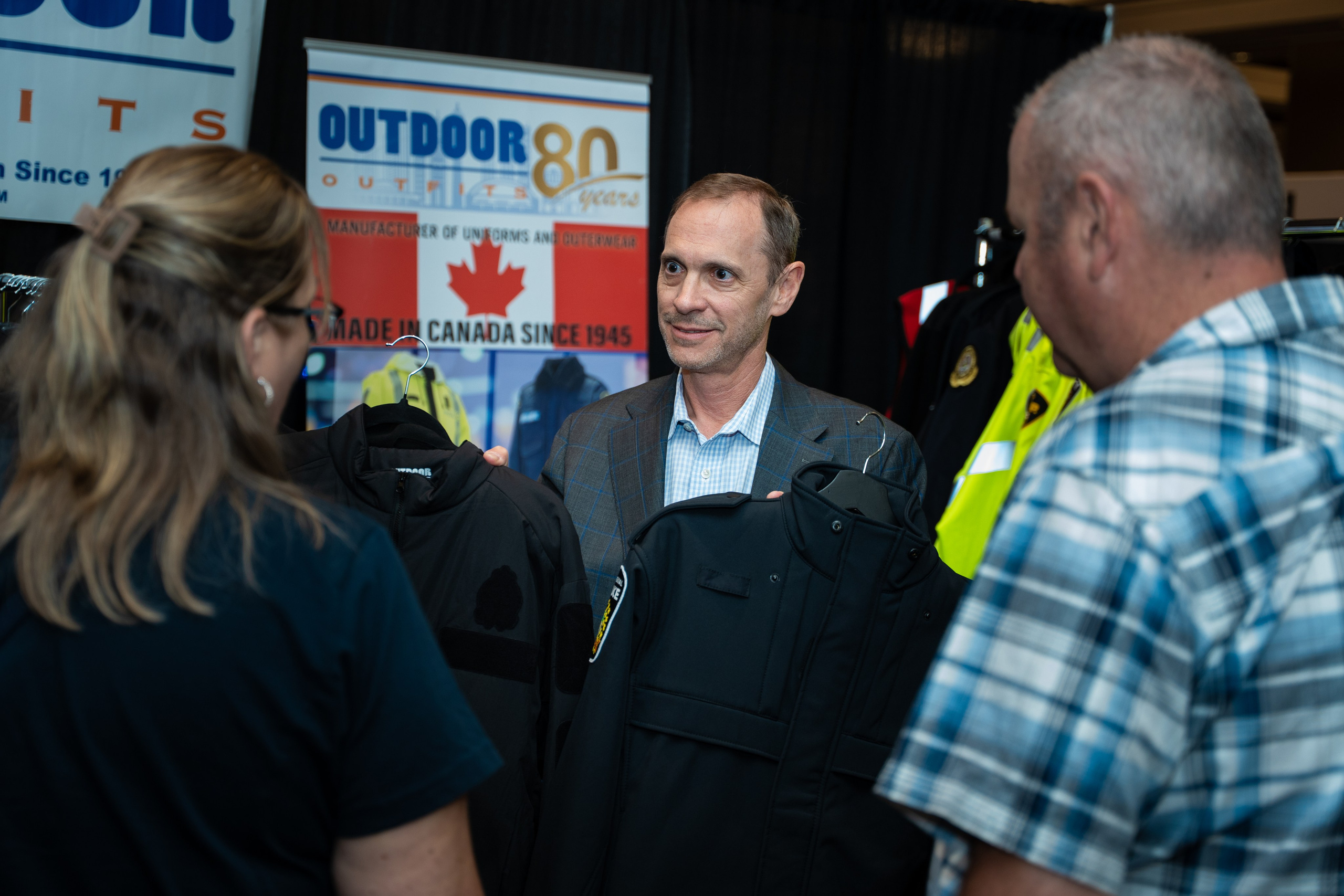 Attendees networking near event booth signage, Blueline Expo 2026