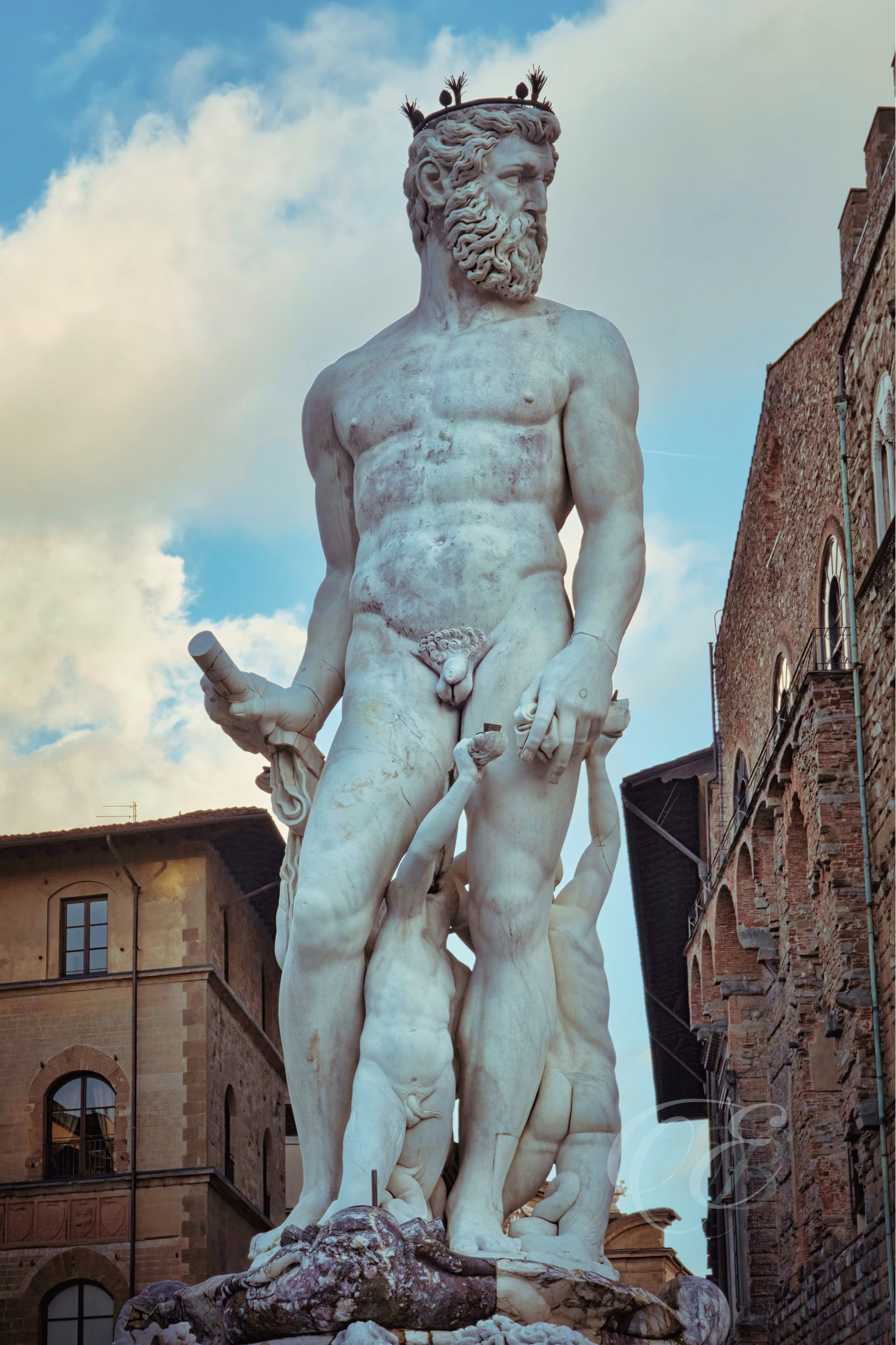 Florence, Italy – Fountain of Neptune in Piazza della Signoria in late afternoon light showing Renaissance marble sculpture and architectural detail – Eduardo Bartoli Photography.