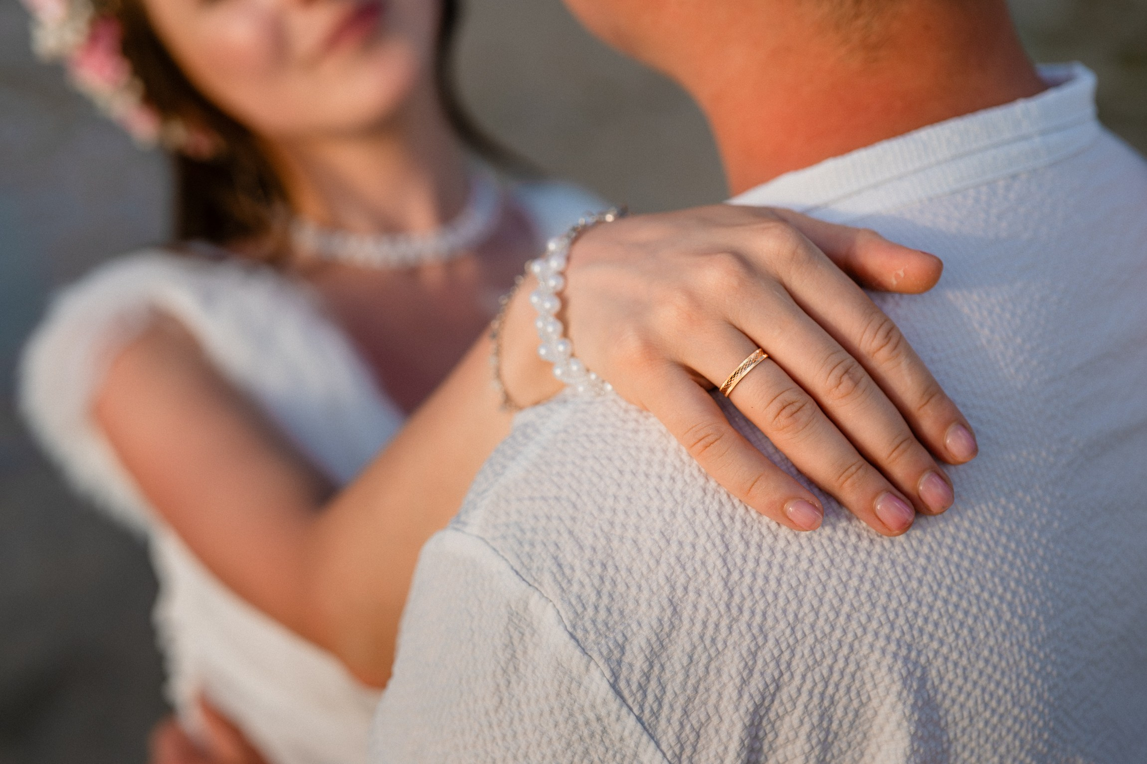 Bride and groom exchanging vows on a private sunset beach