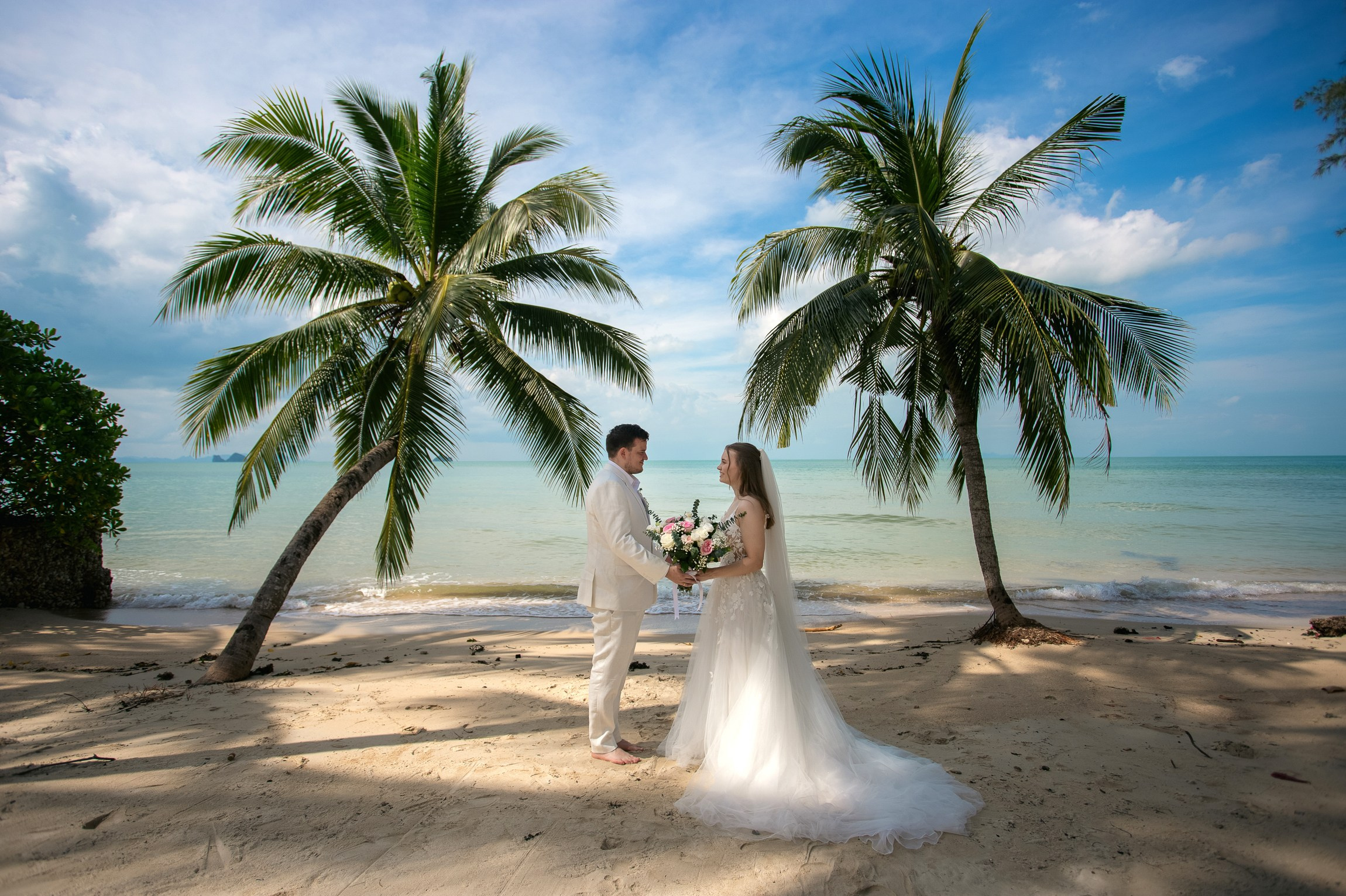 Couple celebrating a private destination wedding for two on a sandy beach in Koh Samui, Thailand