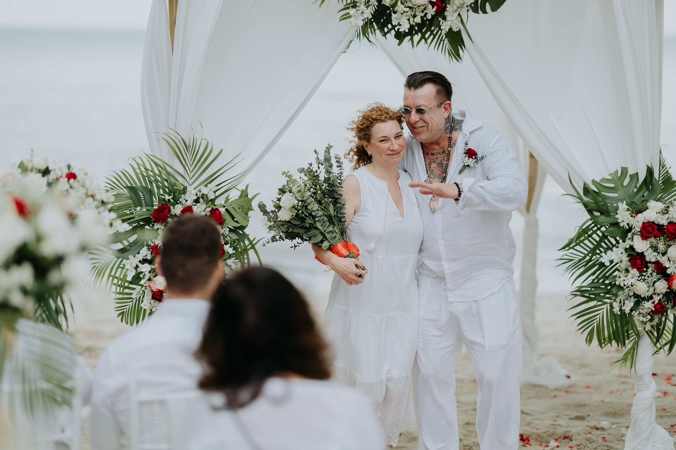 Couple with guests celebrating a spiritual Buddhist wedding ceremony on Koh Samui