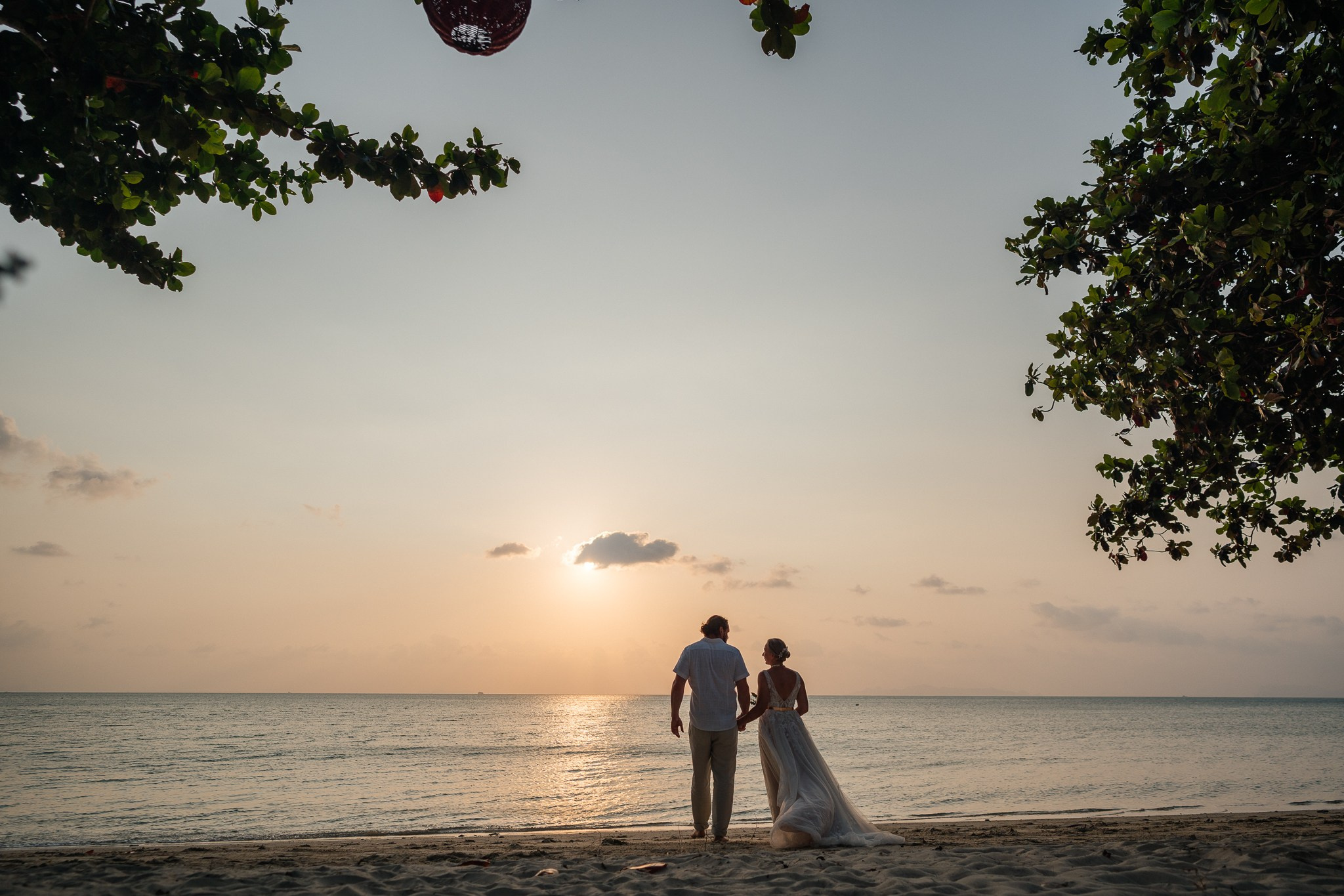 Destination beach wedding in Koh Samui, Thailand with the couple, family members and friends enjoying a tropical wedding ceremony by the sea