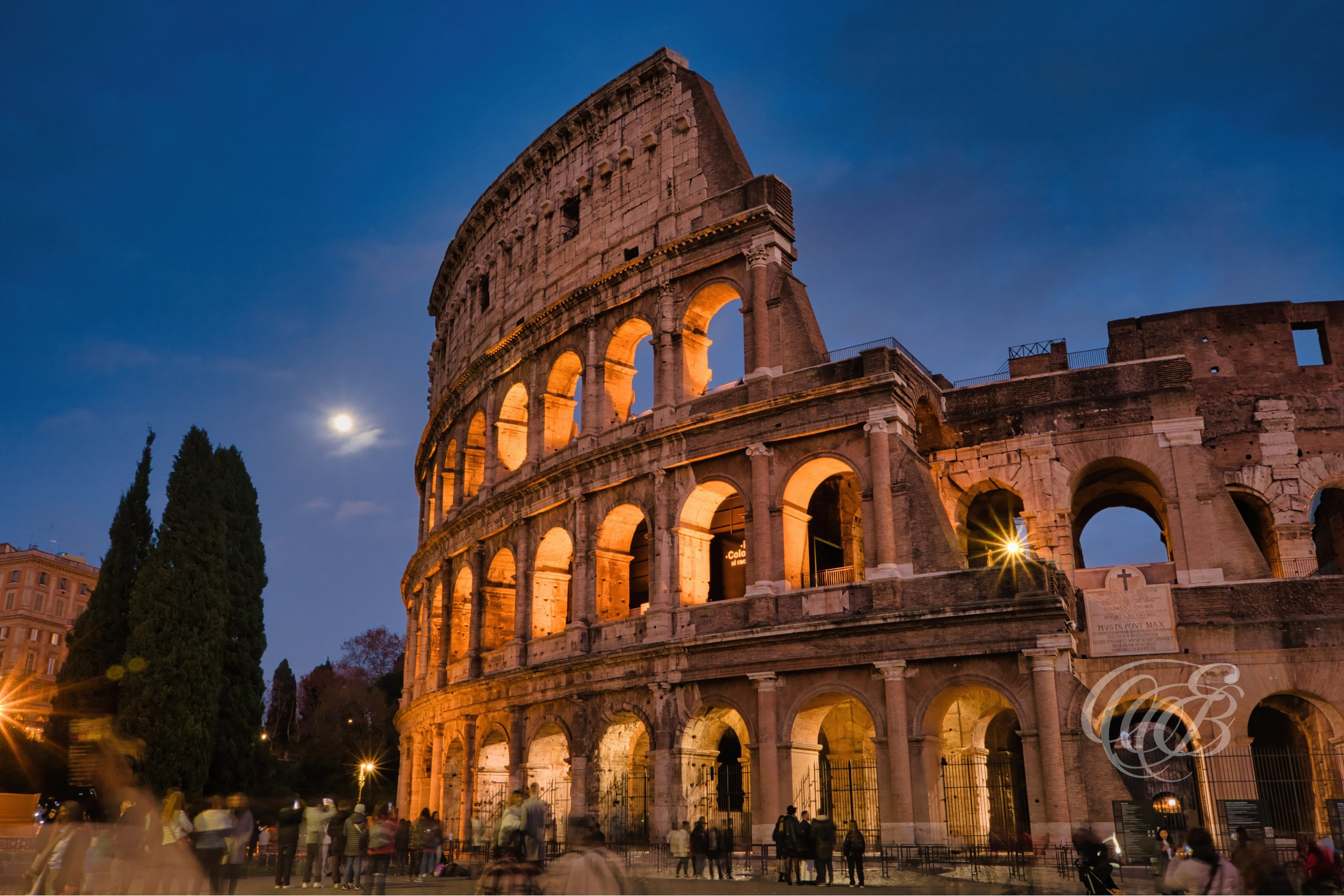 ITALY TRAVEL PHOTOGRAPHY – ITALY – ROME — The Colosseum under the Full Moon — Ancient Roman amphitheater built in the 1st century AD, illuminated by moonlight, showing arches and historic architecture in Rome, Italy — Eduardo Bartoli Photography.