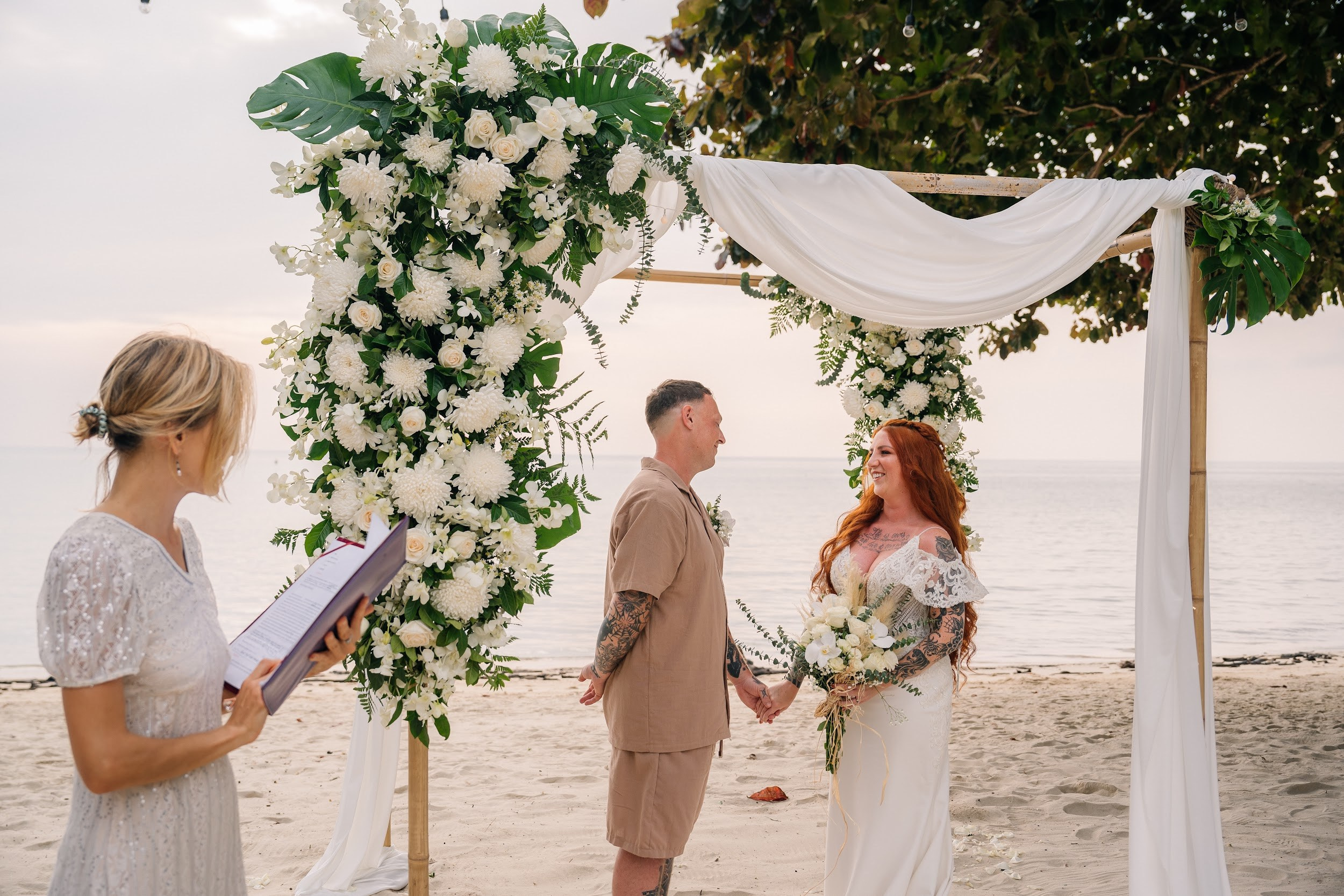 Bride and groom during a romantic beach wedding ceremony on Koh Samui, Thailand, surrounded by tropical scenery and ocean views