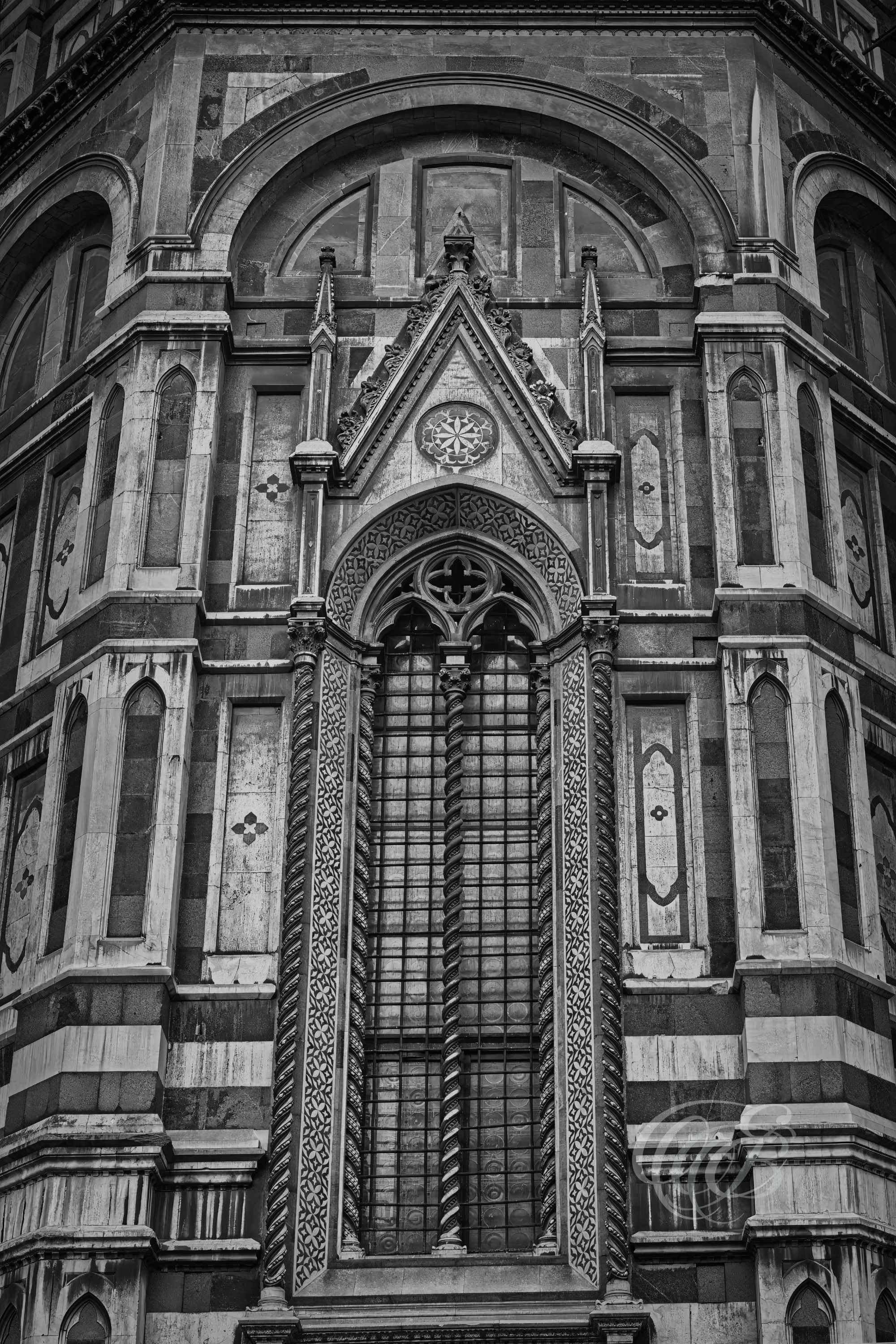 ITALY – FLORENCE — Santa Maria del Fiore Window Detail Black and White — Architectural close-up of cathedral window on Florence Duomo façade, showing carved stone tracery, Gothic-Renaissance design elements, and light-shadow contrast, Florence, Italy — Eduardo Bartoli Photography.