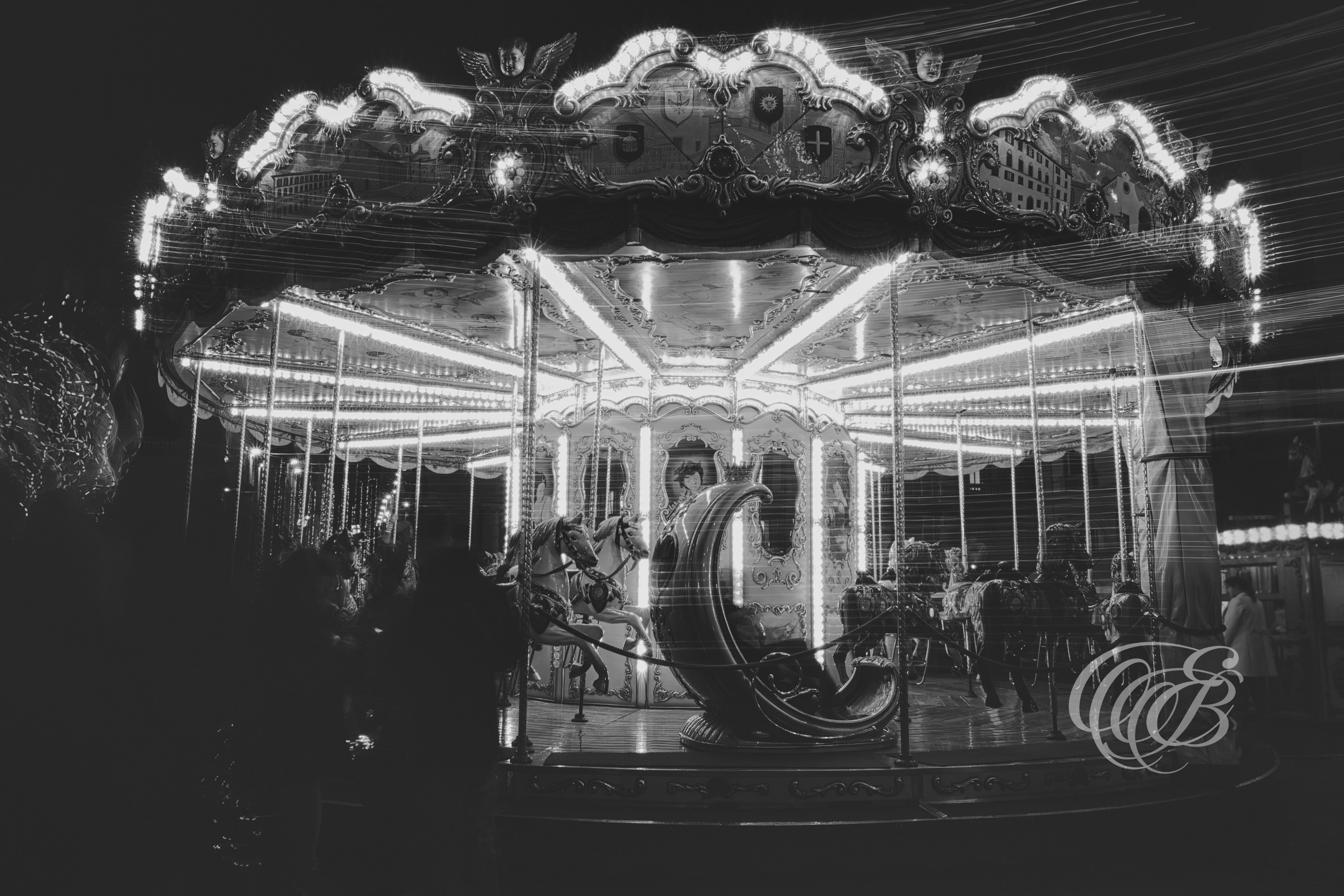 ITALY – FLORENCE — Antica Giostra Toscana Carousel Long Exposure Black and White — Long exposure capture of traditional carousel producing soft light trails and abstract motion effects, matte monochrome aesthetic, Florence, Italy — Eduardo Bartoli Photography.