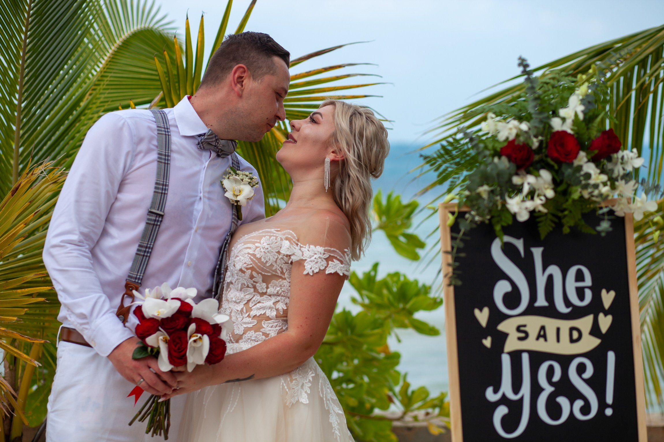 Elegant beach wedding setup on Koh Samui, Thailand with bride, groom, flowers and stunning sea backdrop