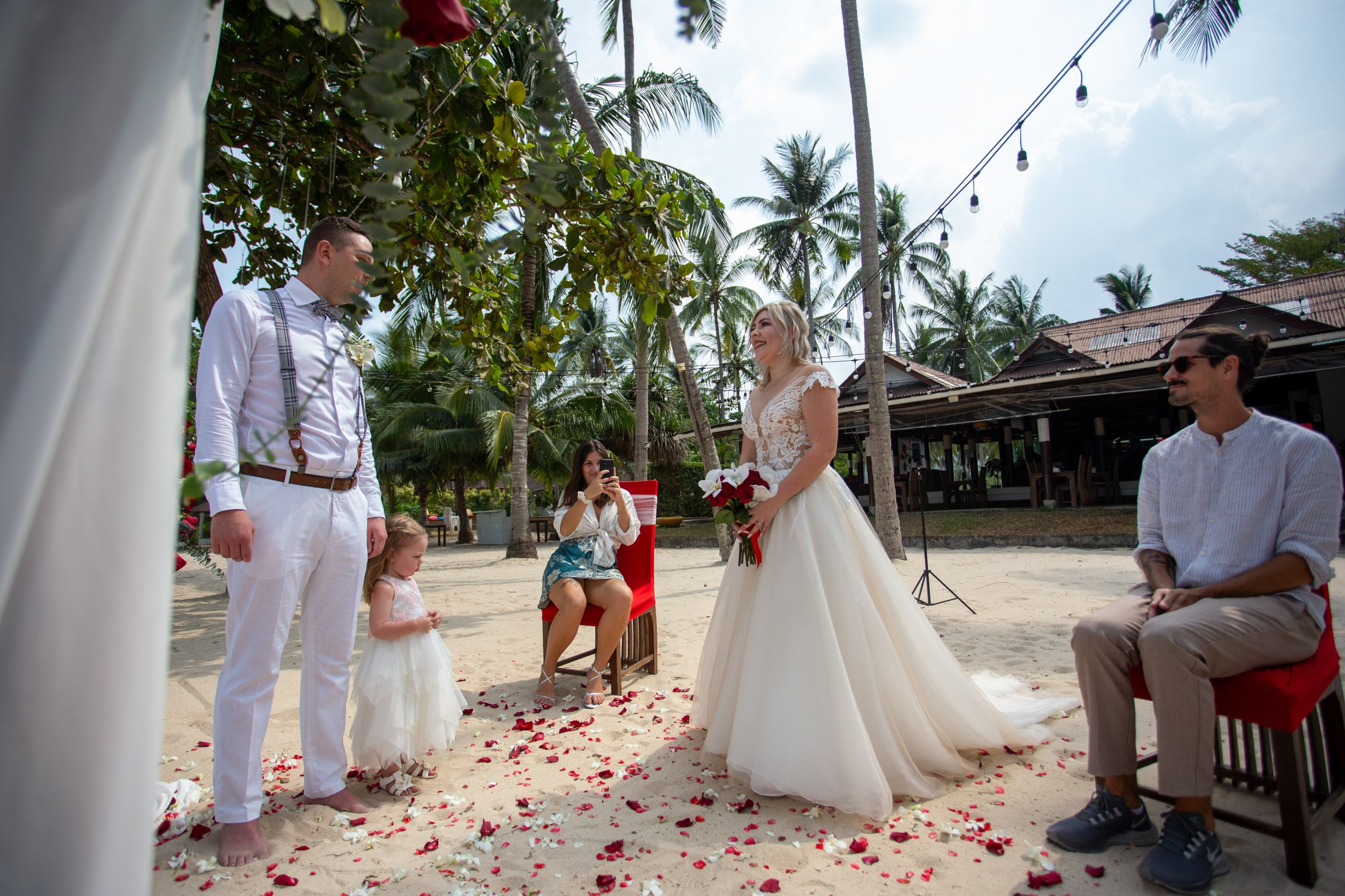 Bride and groom during a romantic beach wedding ceremony on Koh Samui, Thailand, surrounded by tropical scenery and ocean views