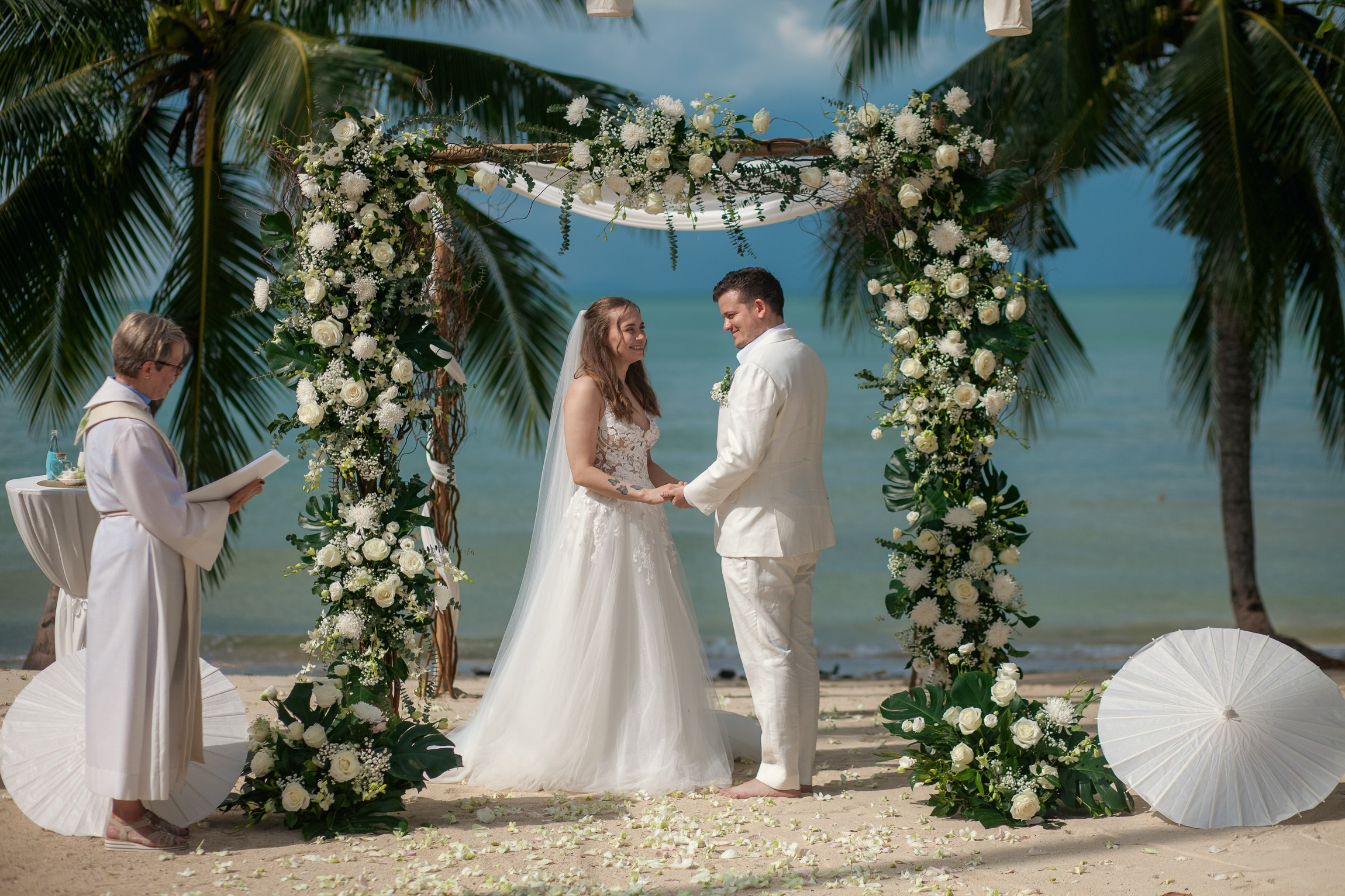 Couple celebrating a private destination wedding for two on a sandy beach in Koh Samui, Thailand