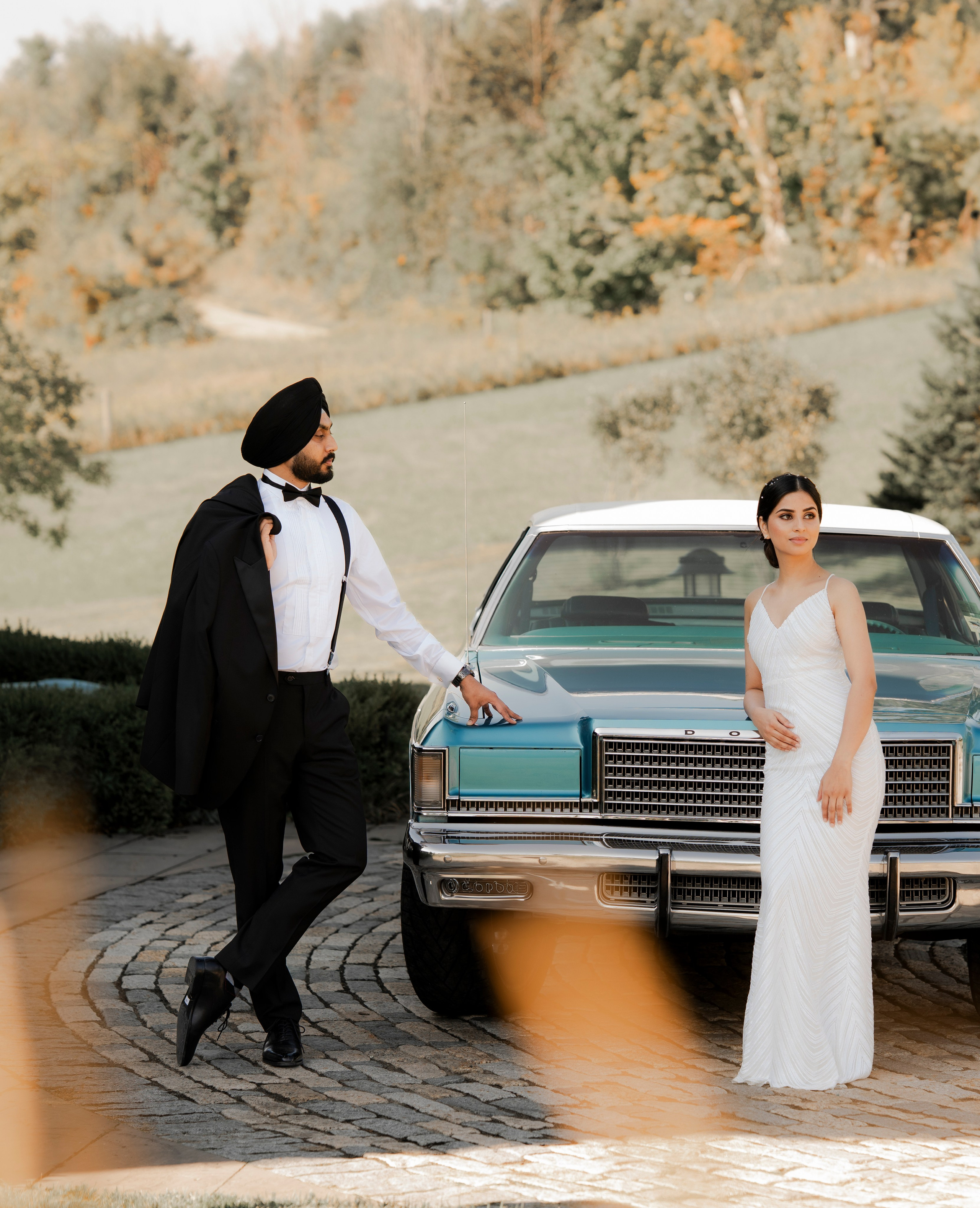 Bride and groom posing near grand pillars of historic architecture