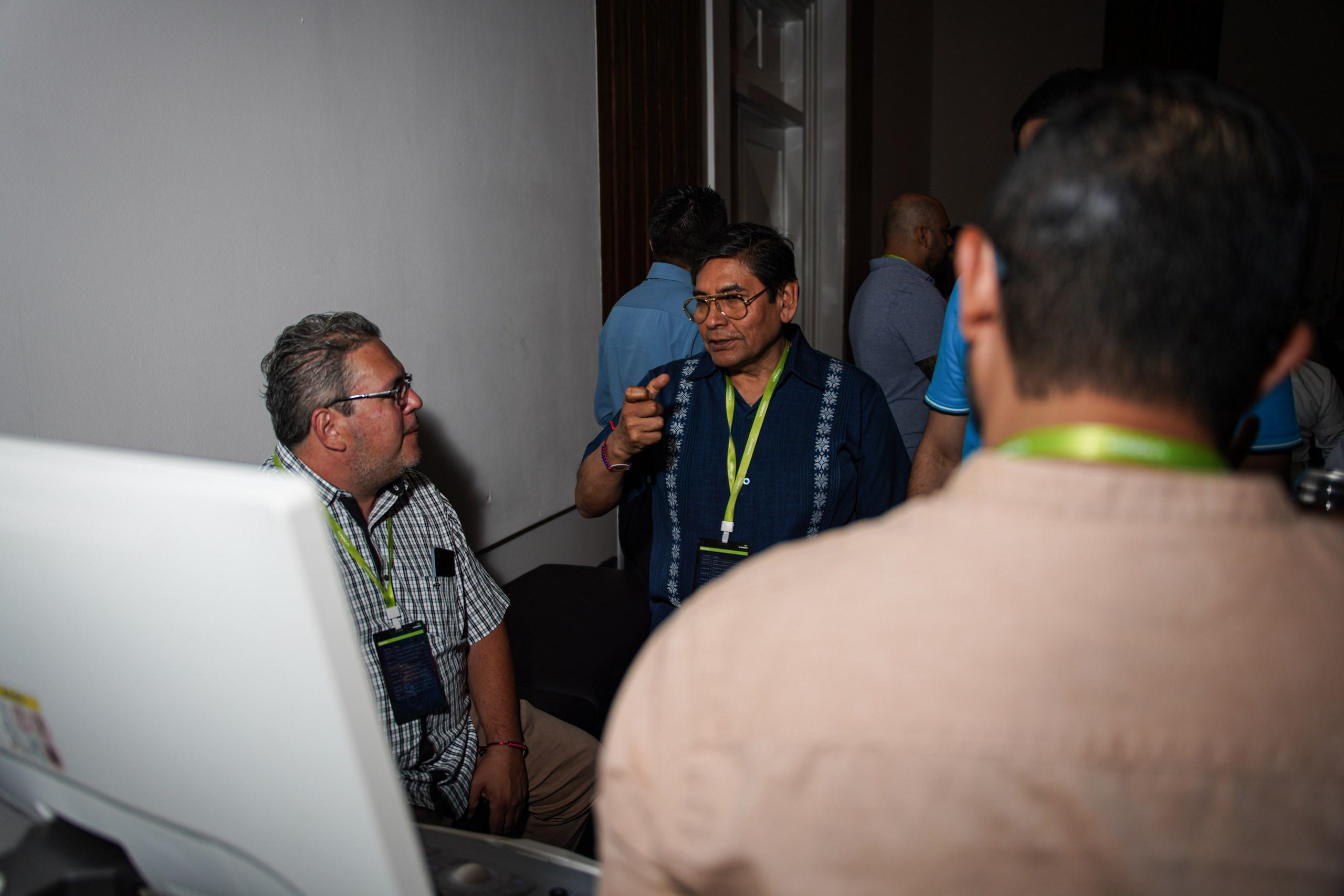Instructor guiding audience through operation of professional medical device.