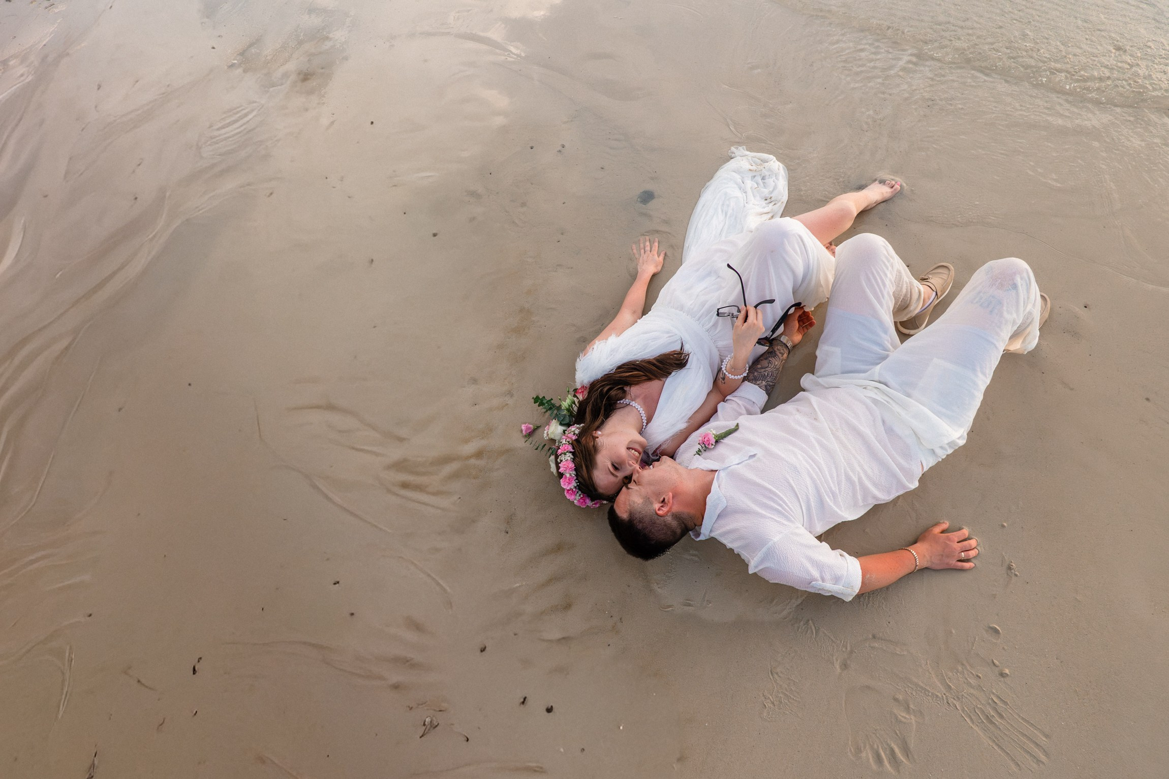 Bride and groom during a romantic beach wedding ceremony on Koh Samui, Thailand, surrounded by tropical scenery and ocean views