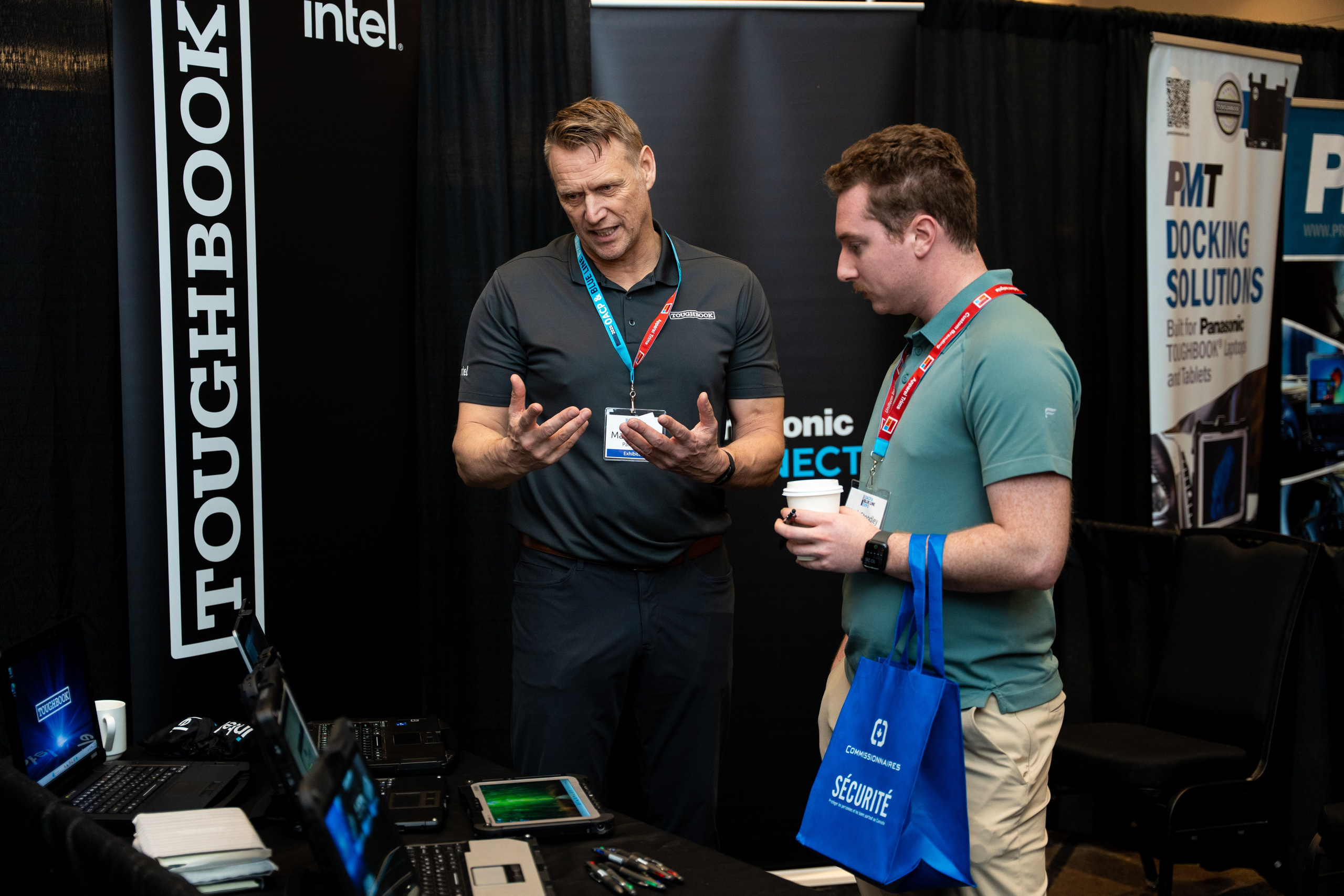 Attendee at exhibitor booth with branded merchandise, Blueline Expo