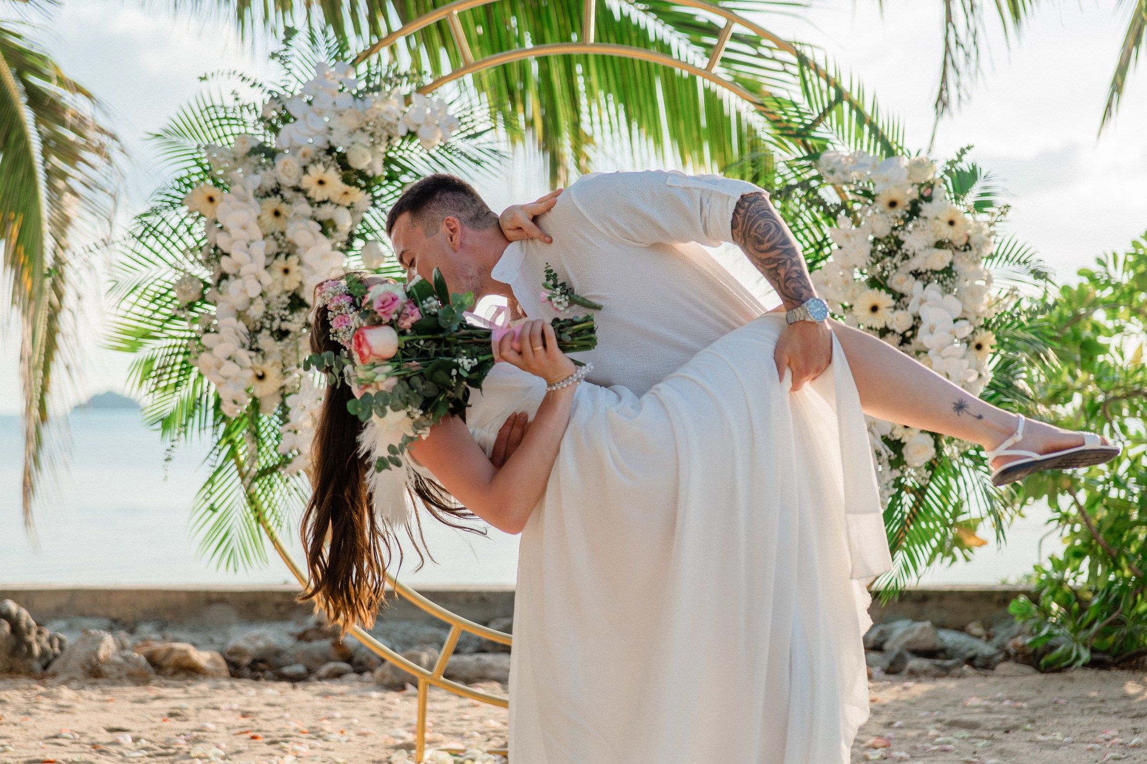 Bride and groom exchanging vows on a private sunset beach