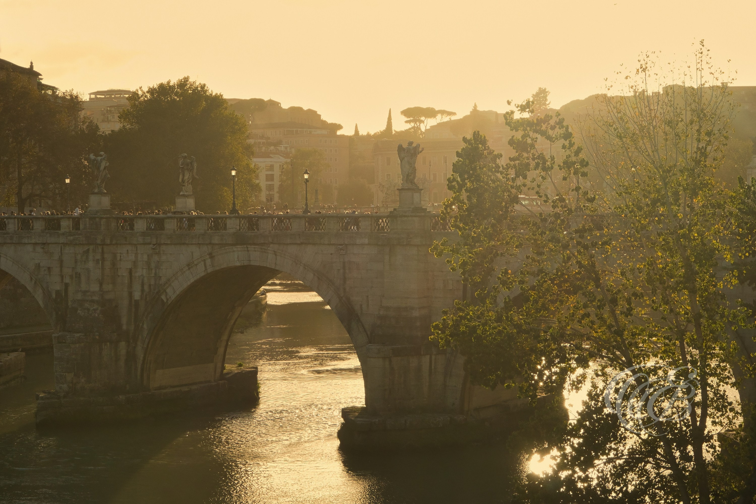 ITALY TRAVEL PHOTOGRAPHY – ITALY – ROME — Ponte Sant’Angelo Warm Sunset — Historic bridge over the Tiber River leading to Castel Sant’Angelo, illuminated by warm evening light and lined with angel sculptures, Rome, Italy — Eduardo Bartoli Photography.